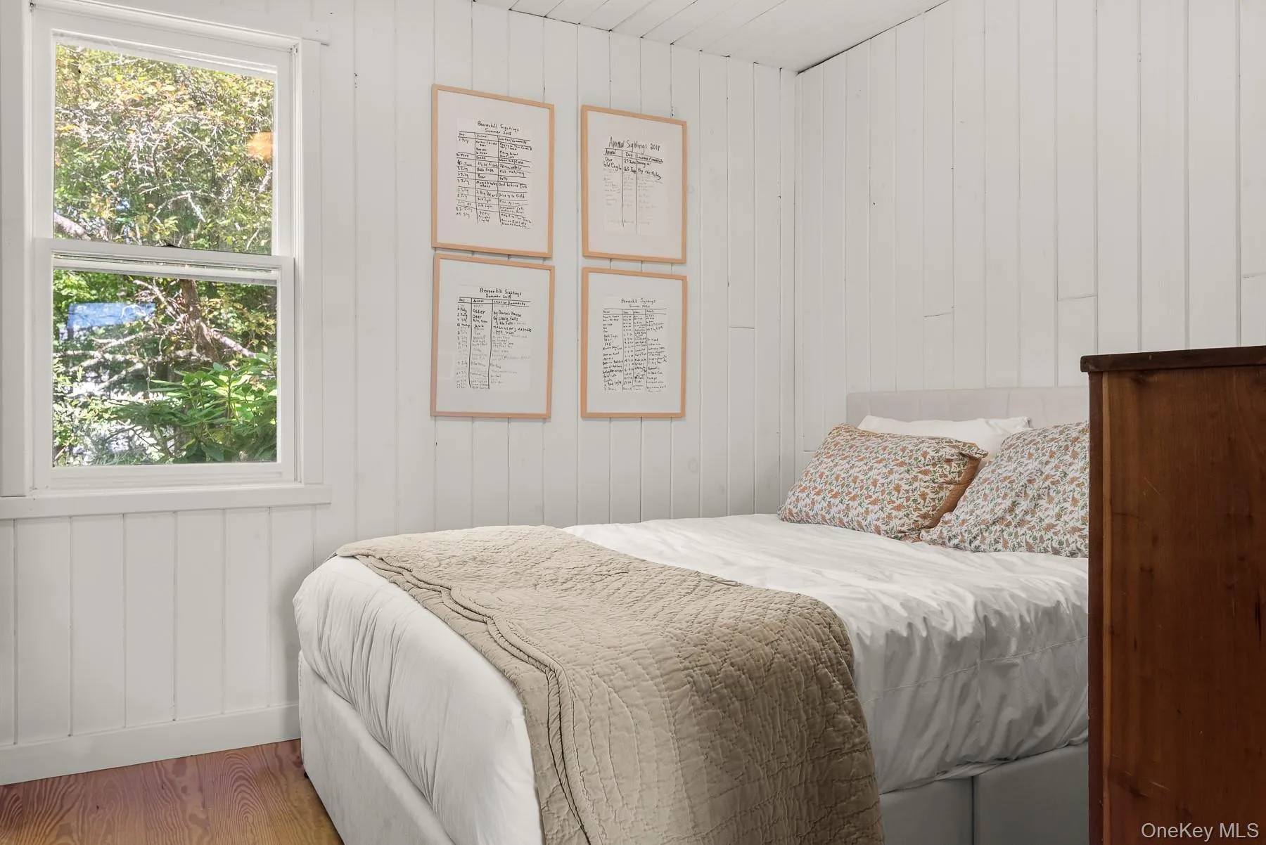 Bedroom with wooden walls and wood finished floors Bedroom with wooden walls and wood finished floors
