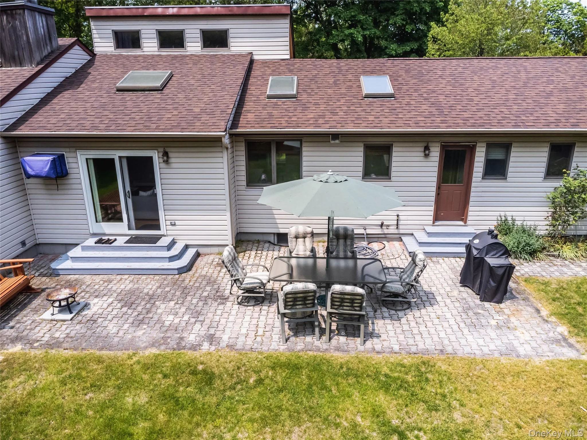 Back of property featuring a patio, entry steps, a shingled roof, and a yard Back of property featuring a patio, entry steps, a shingled roof, and a yard