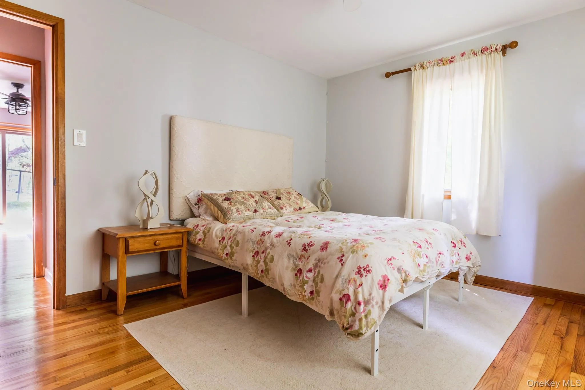 Bedroom featuring baseboards and light wood-style floors Bedroom featuring baseboards and light wood-style floors