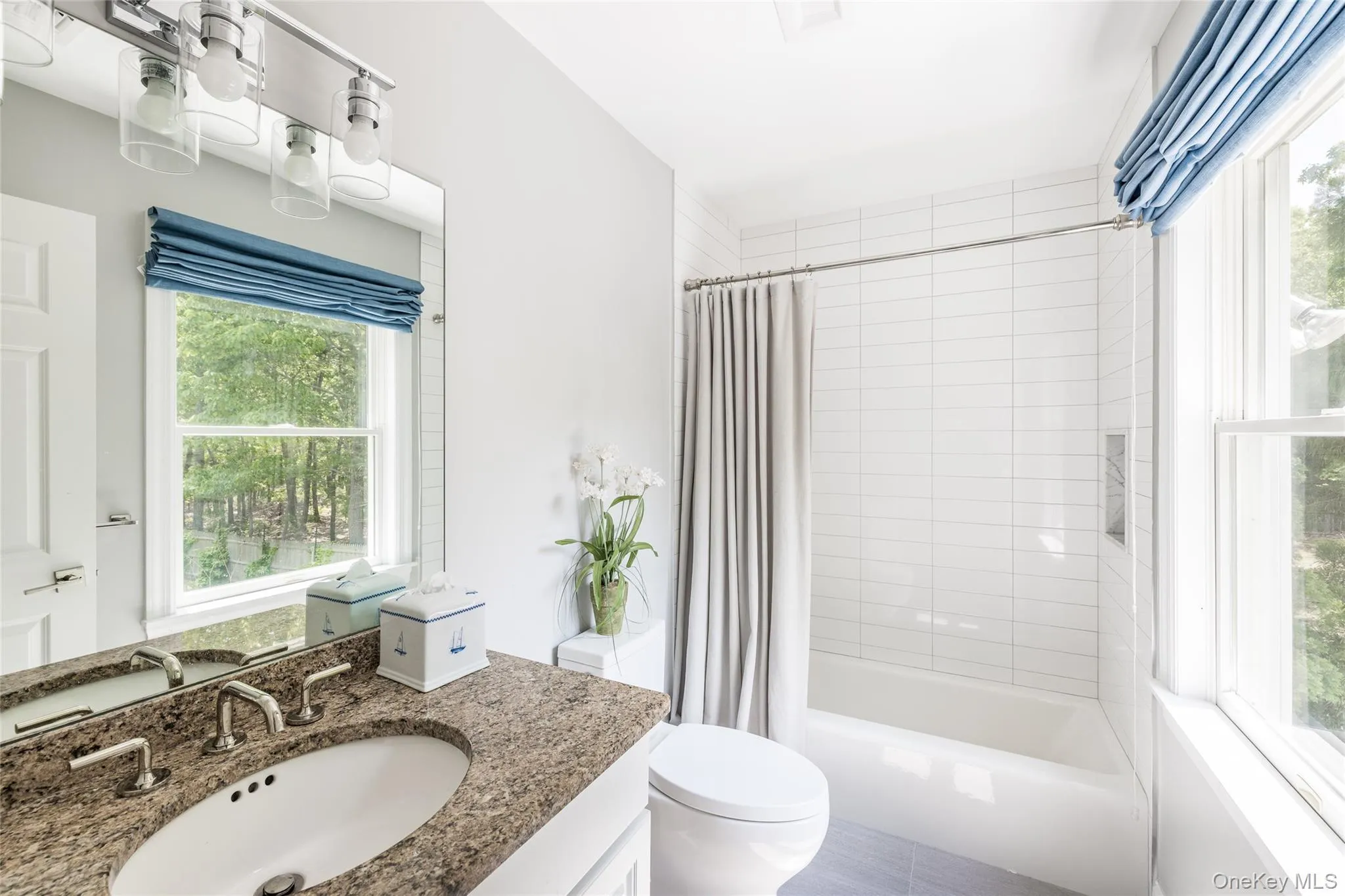 Full bathroom featuring shower / bath combo with shower curtain and vanity Full bathroom featuring shower / bath combo with shower curtain and vanity