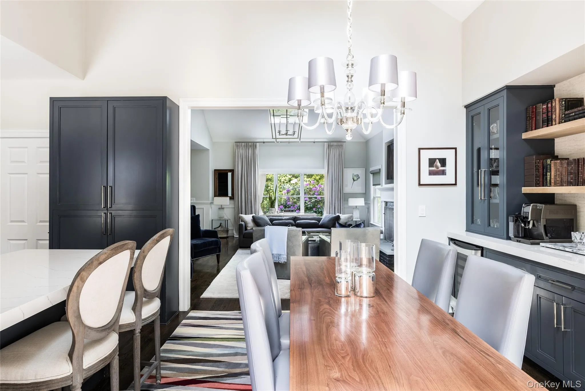 Dining space with a fireplace, a chandelier, and a towering ceiling Dining space with a fireplace, a chandelier, and a towering ceiling