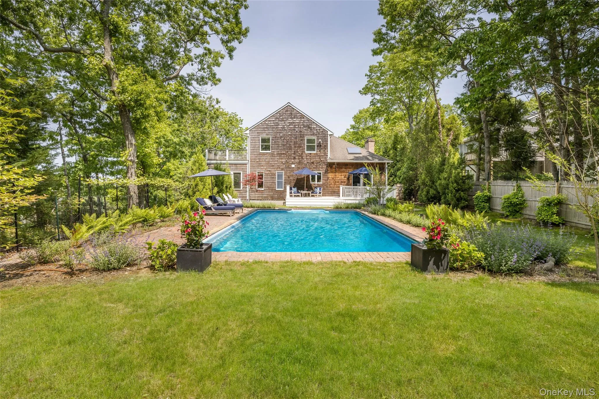View of swimming pool with a deck and a yard View of swimming pool with a deck and a yard