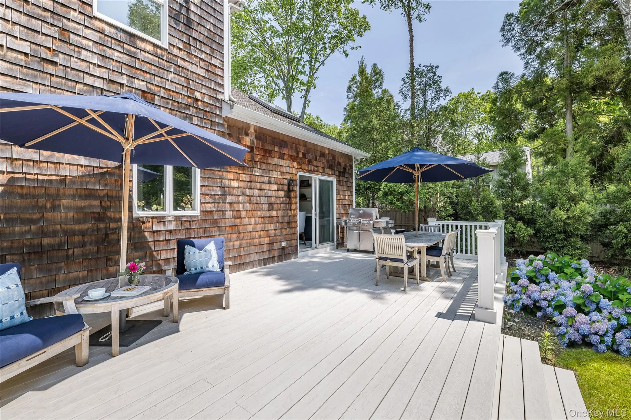 Wooden terrace with outdoor dining area and an outdoor kitchen Wooden terrace with outdoor dining area and an outdoor kitchen