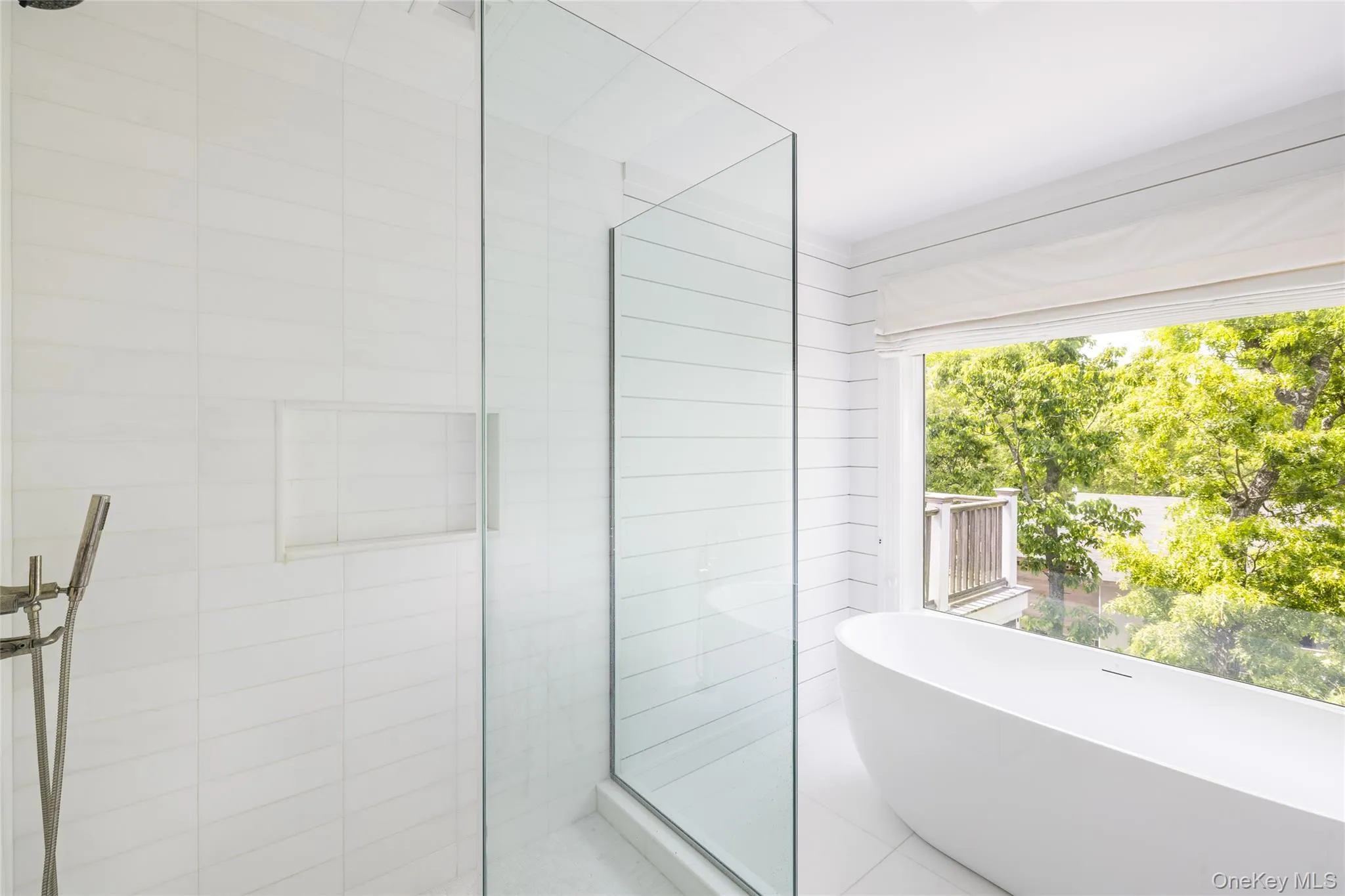 Full bathroom featuring a stall shower and a freestanding tub Full bathroom featuring a stall shower and a freestanding tub