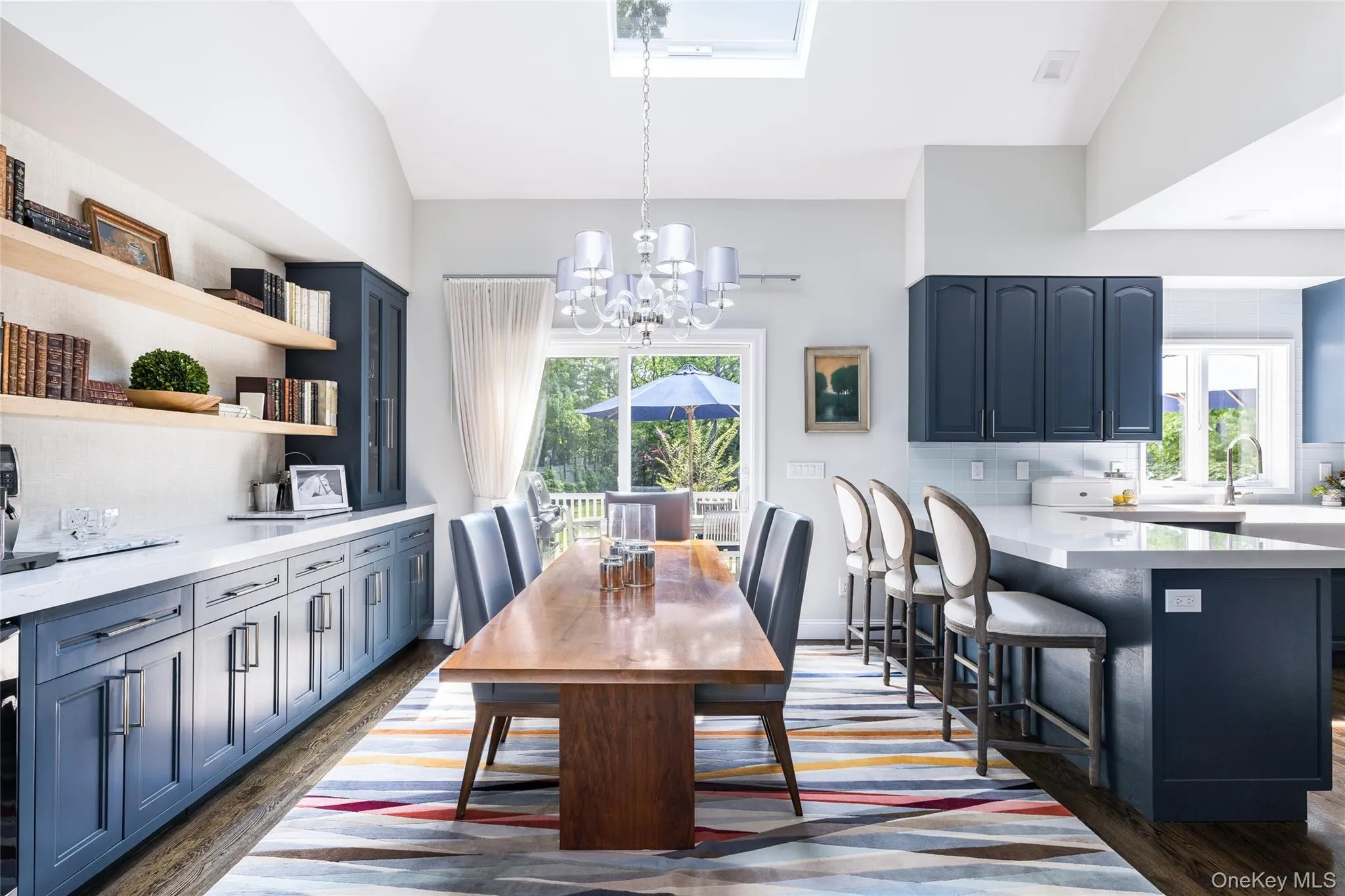 Dining area featuring dark wood finished floors, vaulted ceiling, and a chandelier Dining area featuring dark wood finished floors, vaulted ceiling, and a chandelier