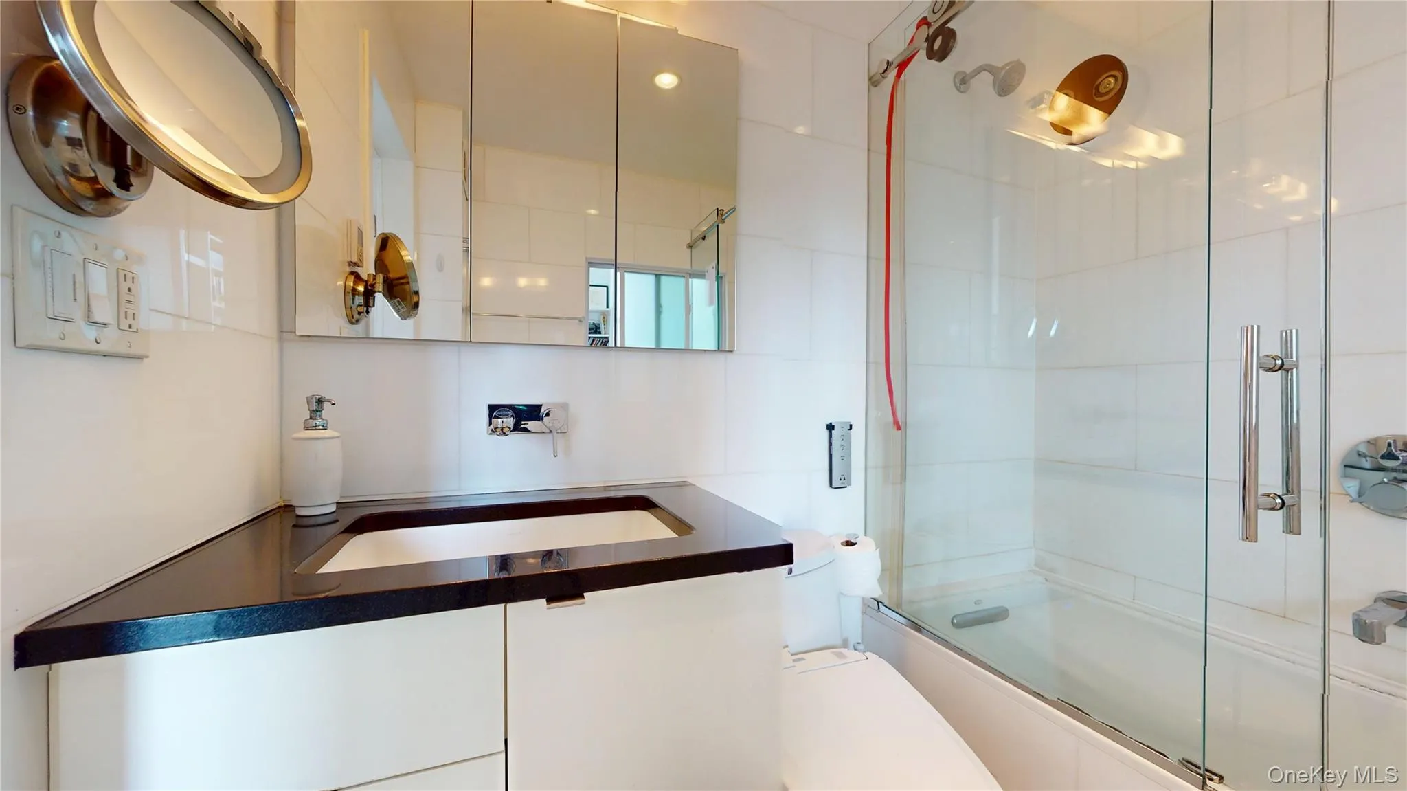 Full bath featuring shower / bath combination with glass door and vanity Full bath featuring shower / bath combination with glass door and vanity