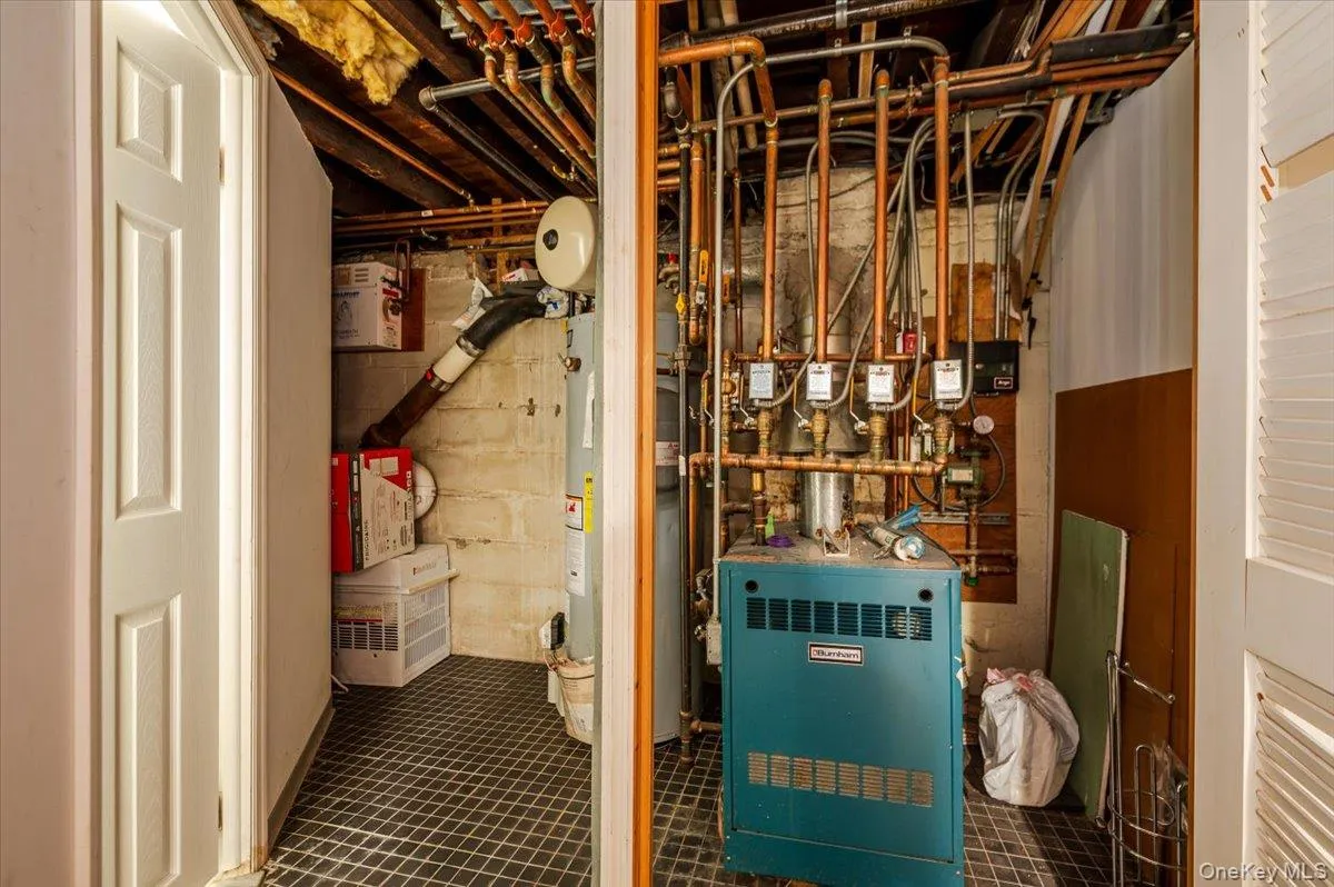 Utility room featuring a heating unit and gas water heater Utility room featuring a heating unit and gas water heater