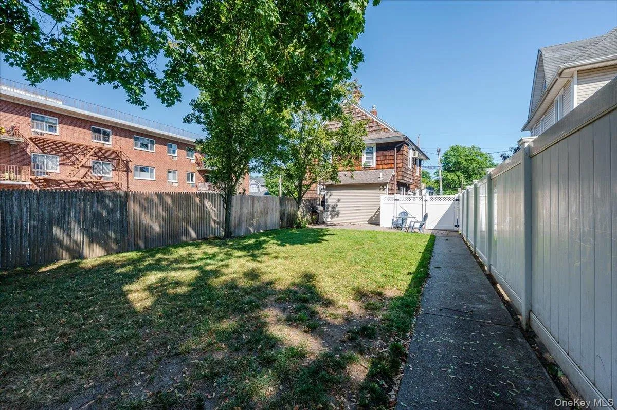Fenced backyard featuring a gate Fenced backyard featuring a gate