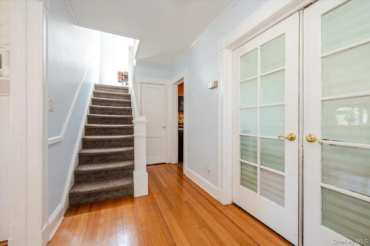 Stairway with hardwood / wood-style flooring and crown molding Stairway with hardwood / wood-style flooring and crown molding