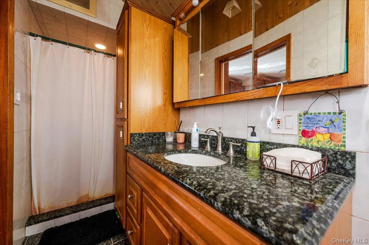 Bathroom featuring vanity and tile patterned floors Bathroom featuring vanity and tile patterned floors