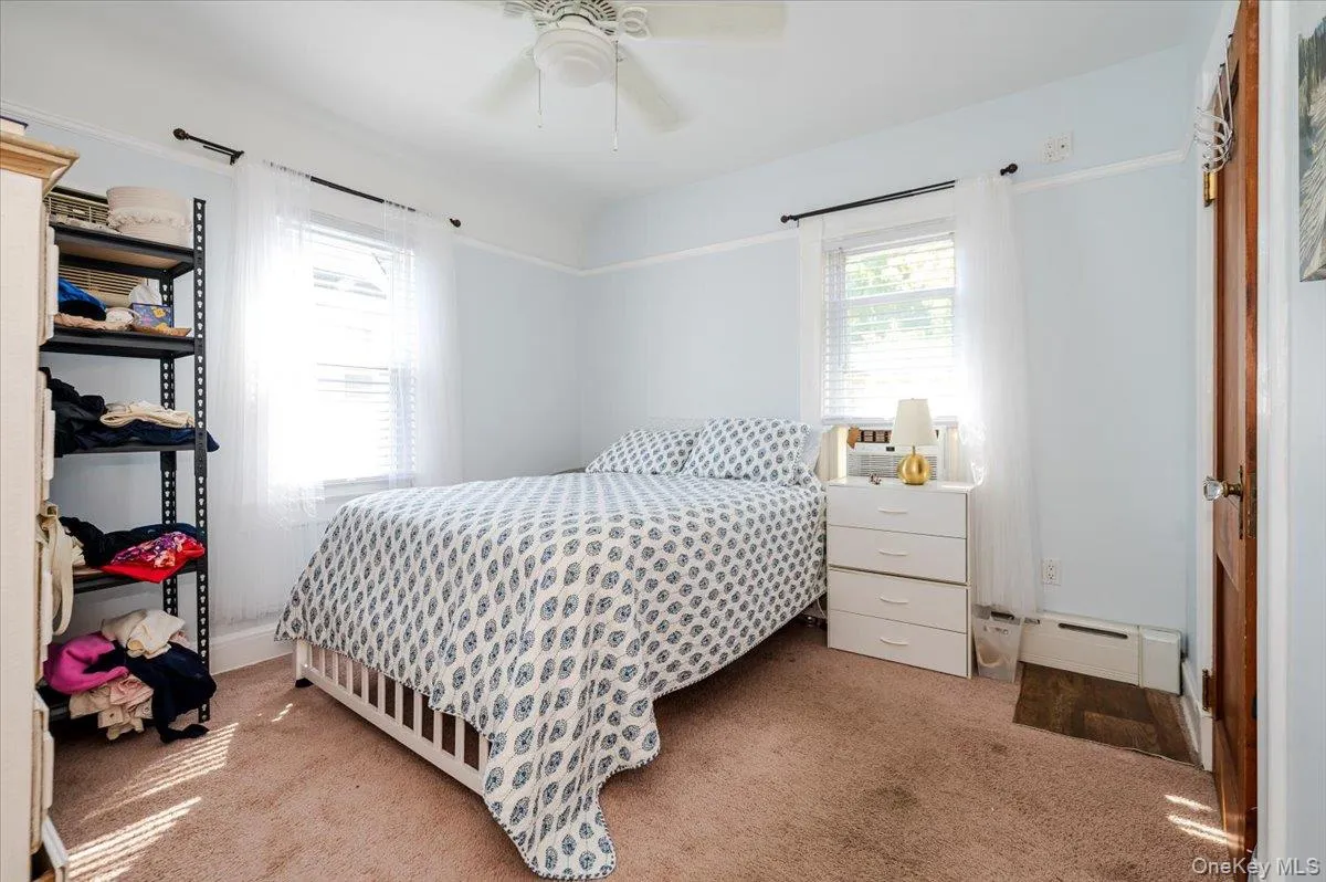 Bedroom with light carpet and a ceiling fan Bedroom with light carpet and a ceiling fan