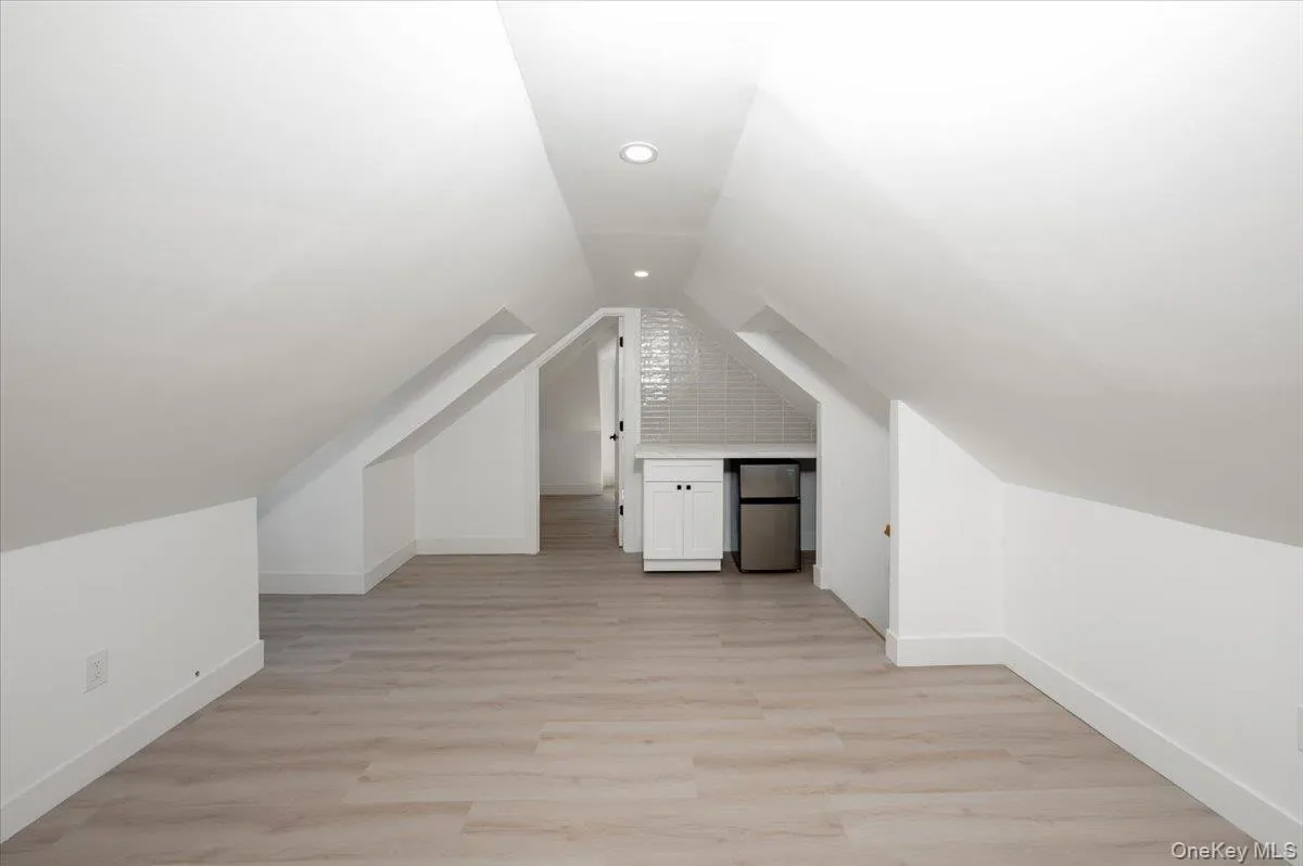 Bonus room with light wood-type flooring and vaulted ceiling Bonus room with light wood-type flooring and vaulted ceiling