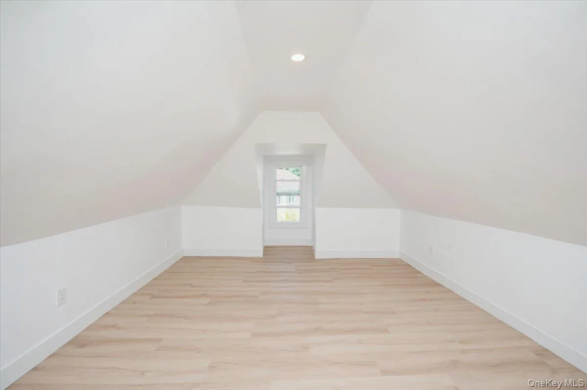 Bonus room with light wood-type flooring, lofted ceiling, and recessed lighting Bonus room with light wood-type flooring, lofted ceiling, and recessed lighting