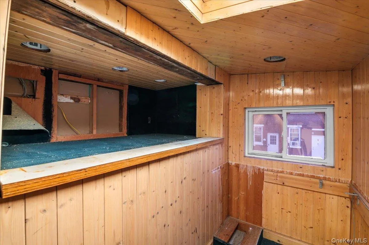 Indoor bar featuring wood walls and wood ceiling Indoor bar featuring wood walls and wood ceiling