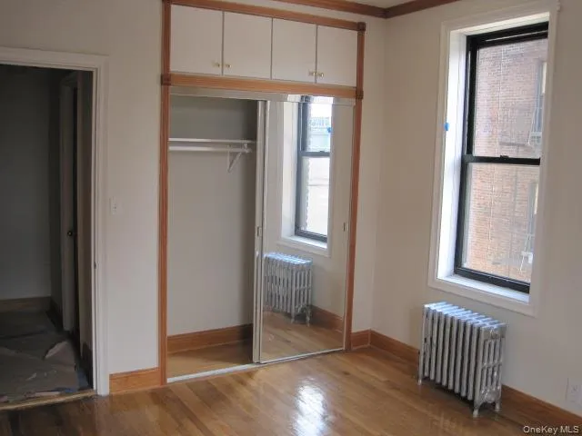 Closet featuring radiator heating unit Closet featuring radiator heating unit