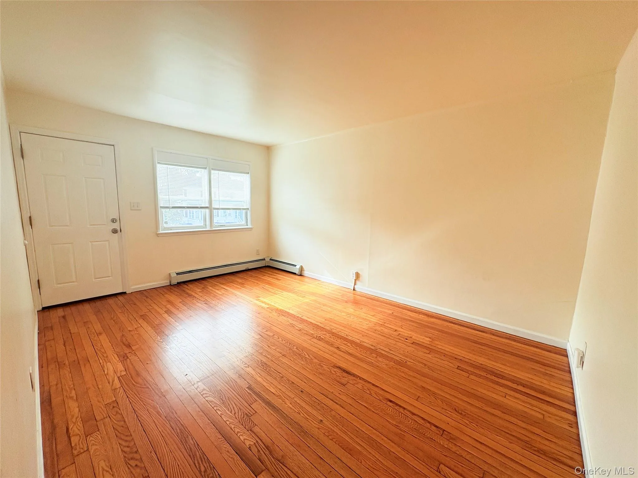 Empty room featuring light wood finished floors and baseboards Empty room featuring light wood finished floors and baseboards