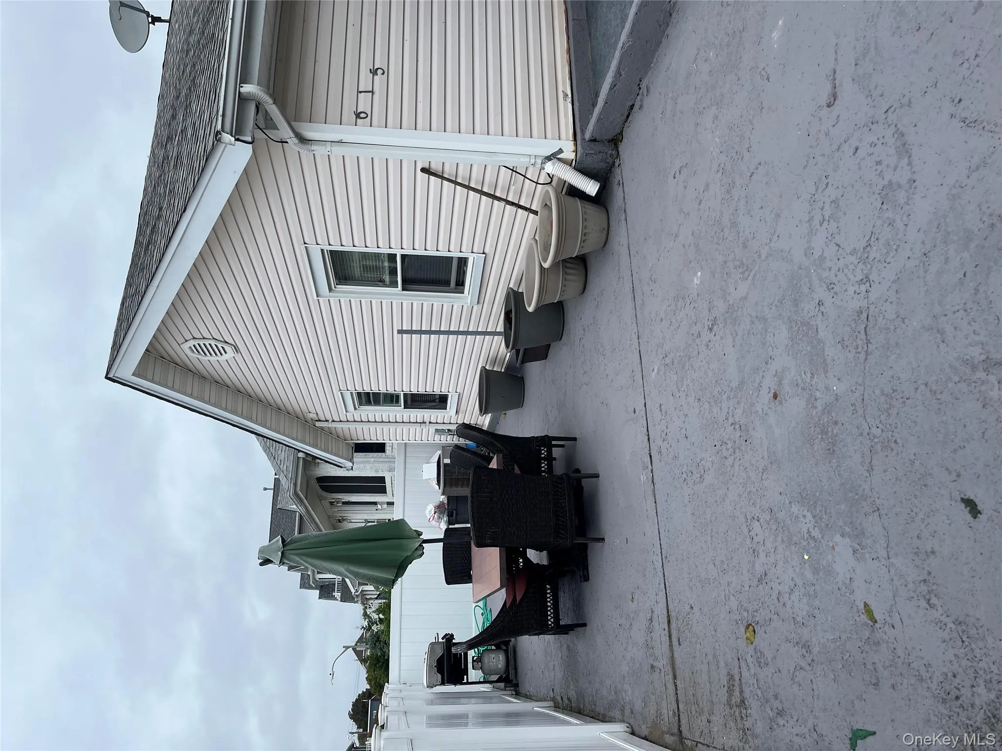 Rear view of property with a patio, outdoor dining space, and a shingled roof Rear view of property with a patio, outdoor dining space, and a shingled roof