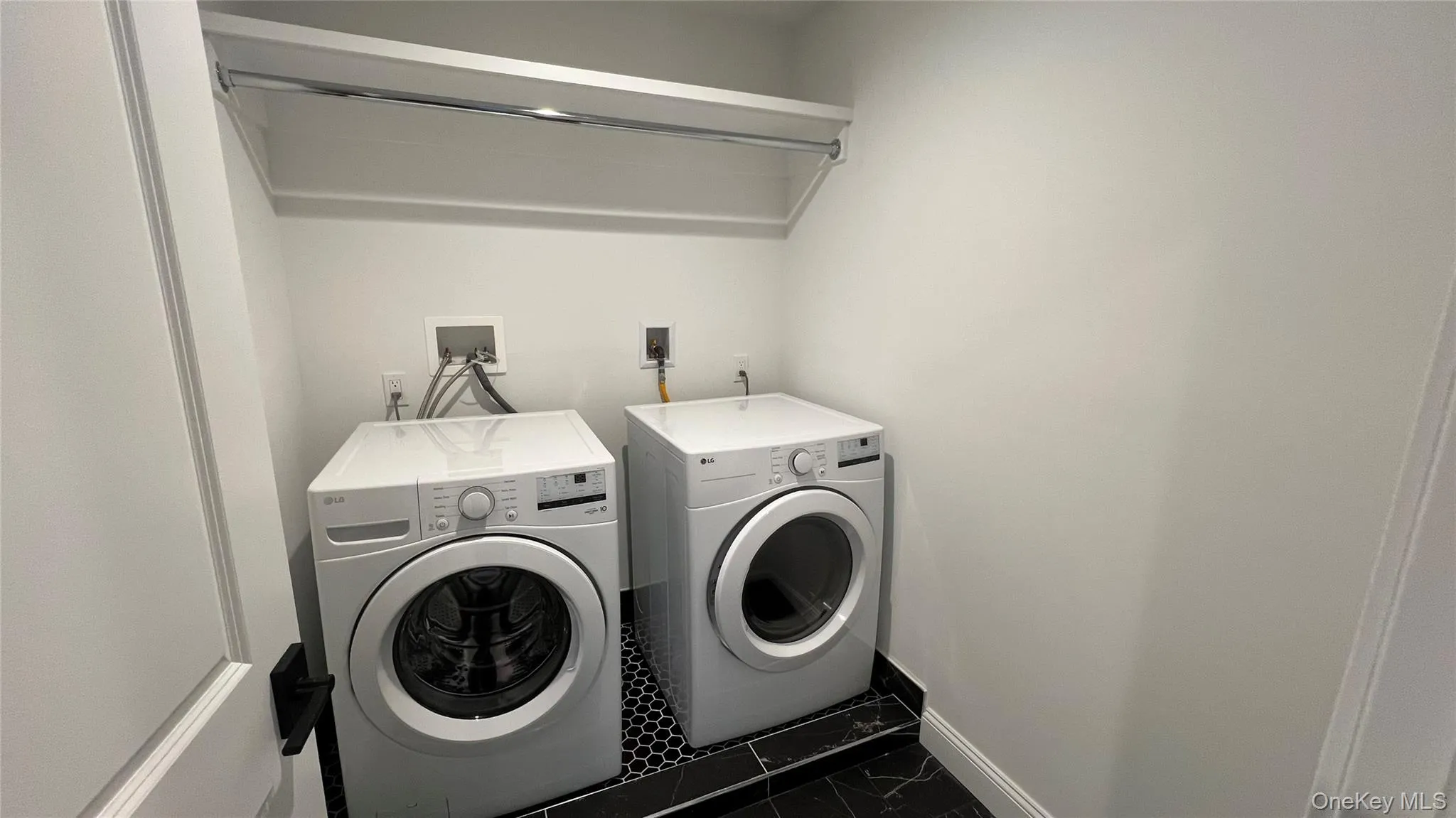 Laundry room with washer and clothes dryer and baseboards Laundry room with washer and clothes dryer and baseboards