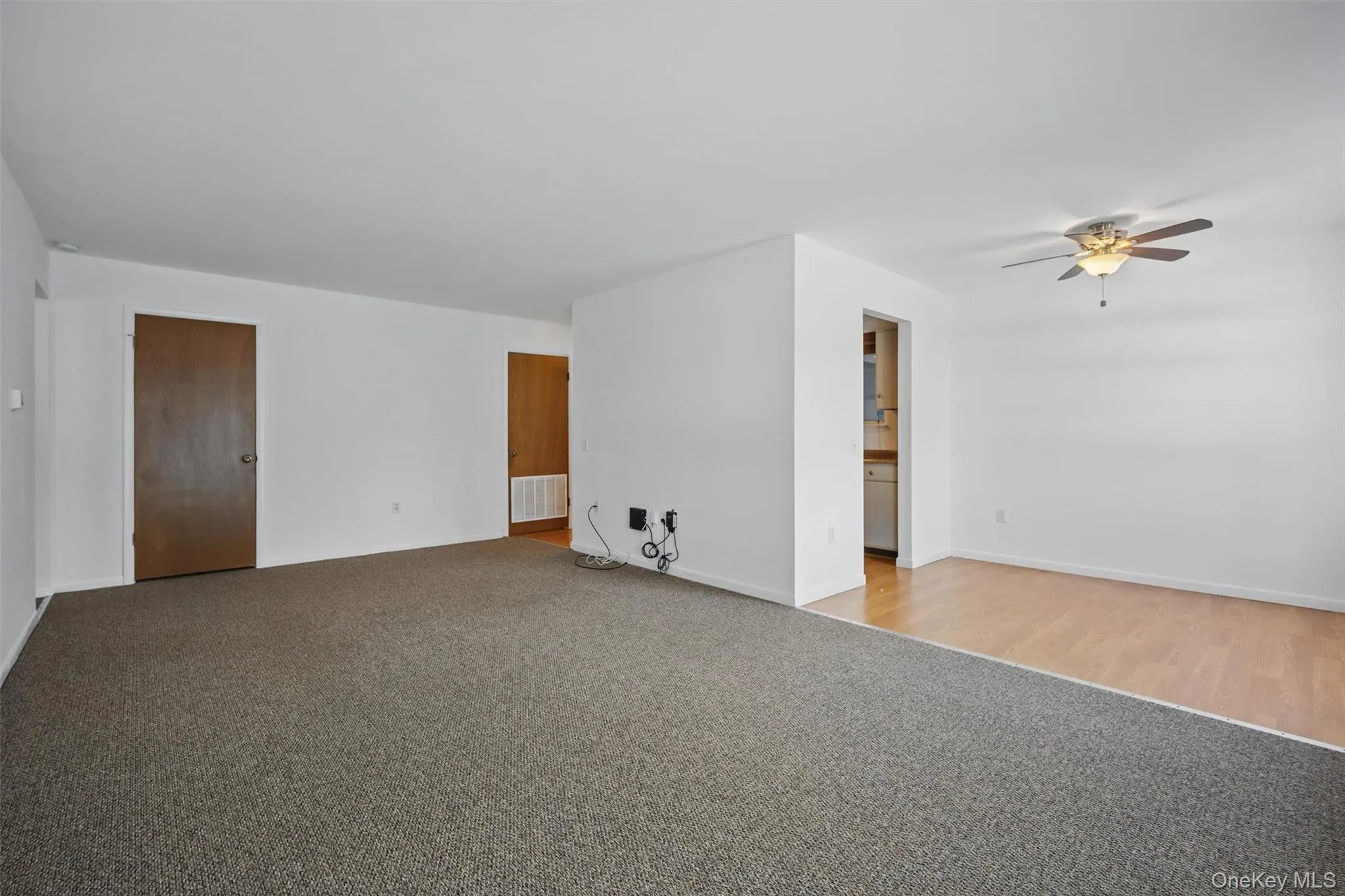 Spare room featuring light carpet and ceiling fan Spare room featuring light carpet and ceiling fan
