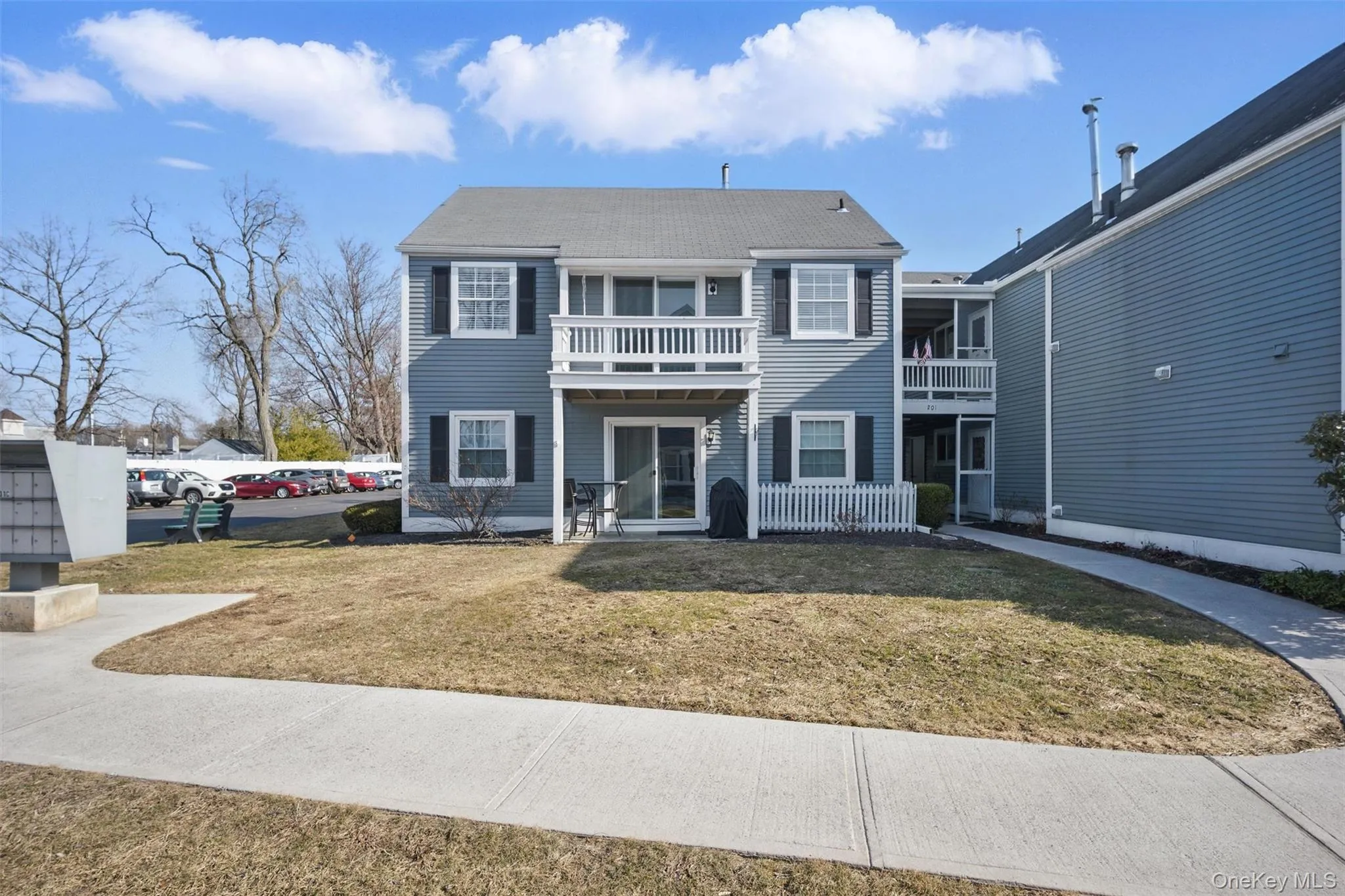 Traditional-style house with a front yard and a balcony Traditional-style house with a front yard and a balcony