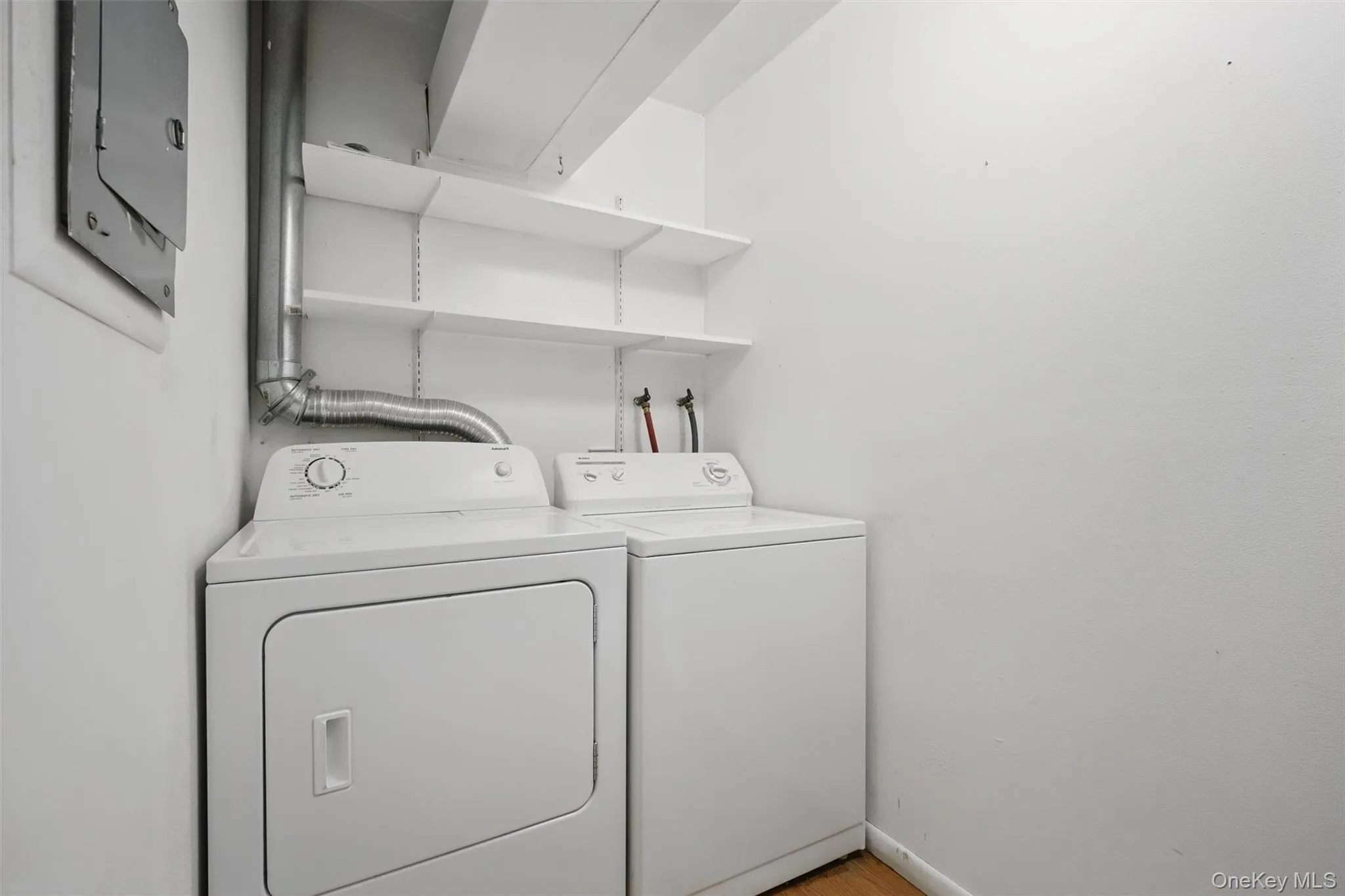 Laundry area with washing machine and dryer and baseboards Laundry area with washing machine and dryer and baseboards