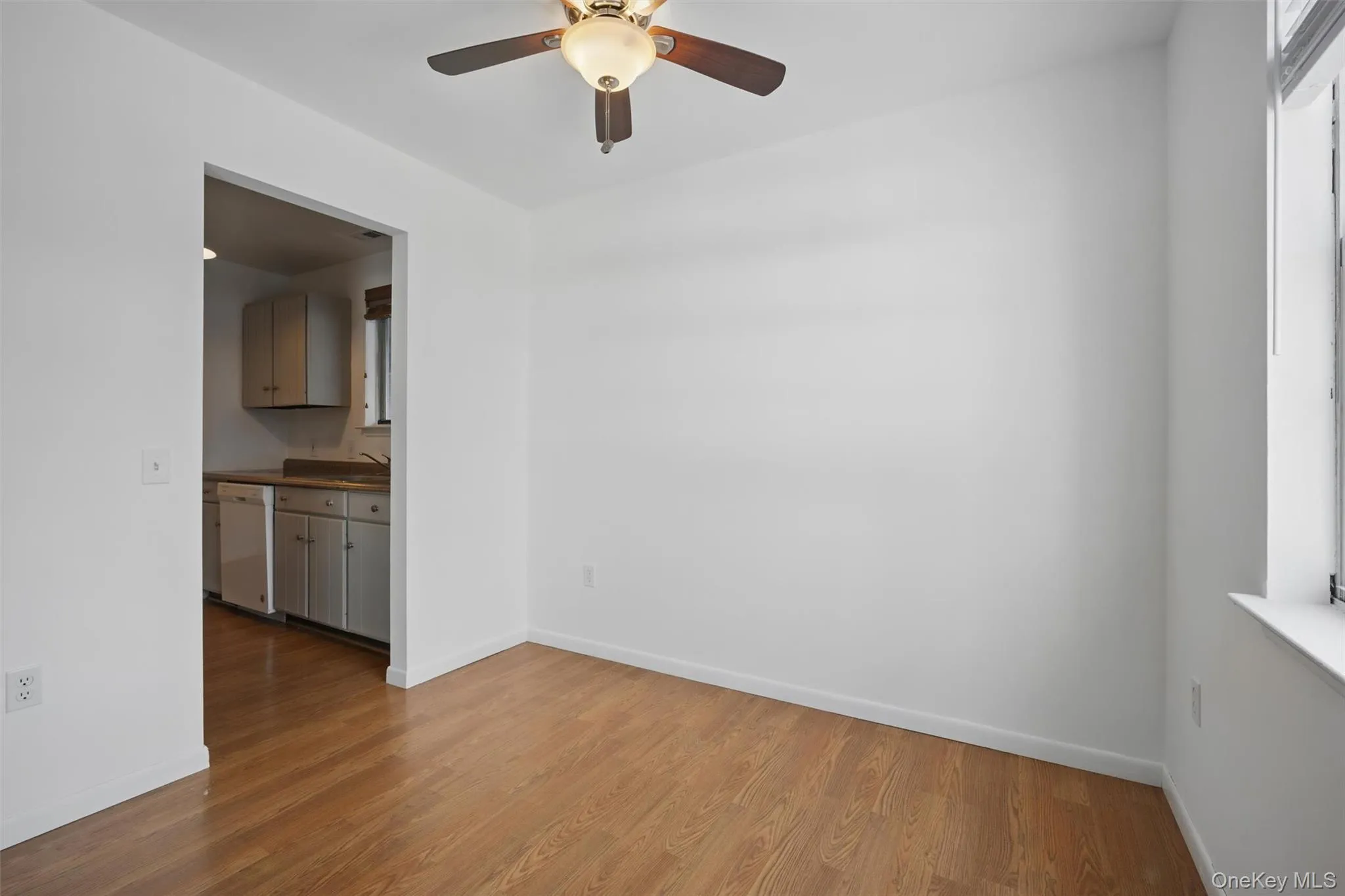 Unfurnished room with light wood-style floors and ceiling fan Unfurnished room with light wood-style floors and ceiling fan