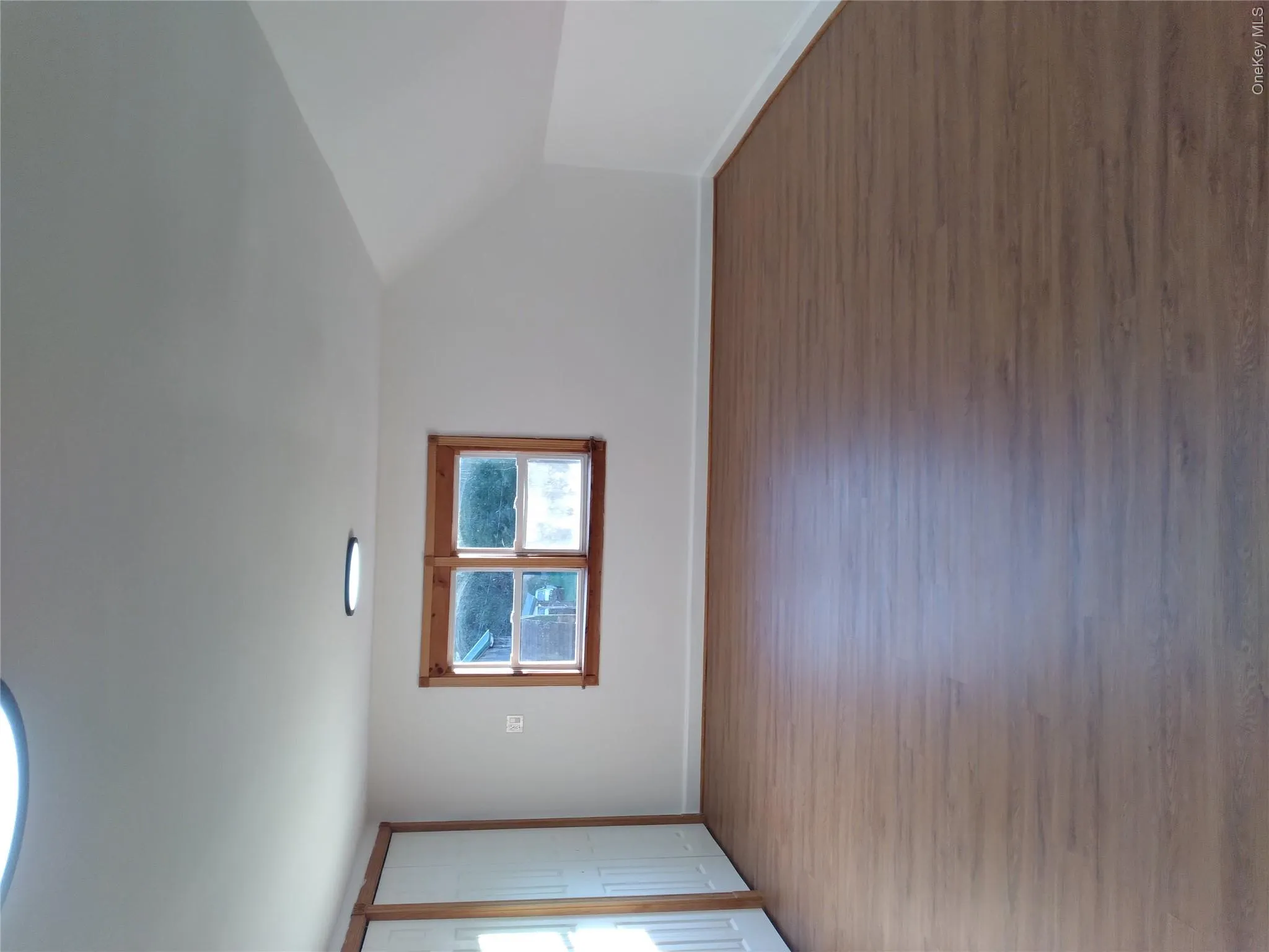 Additional living space with dark wood-style flooring and vaulted ceiling Additional living space with dark wood-style flooring and vaulted ceiling