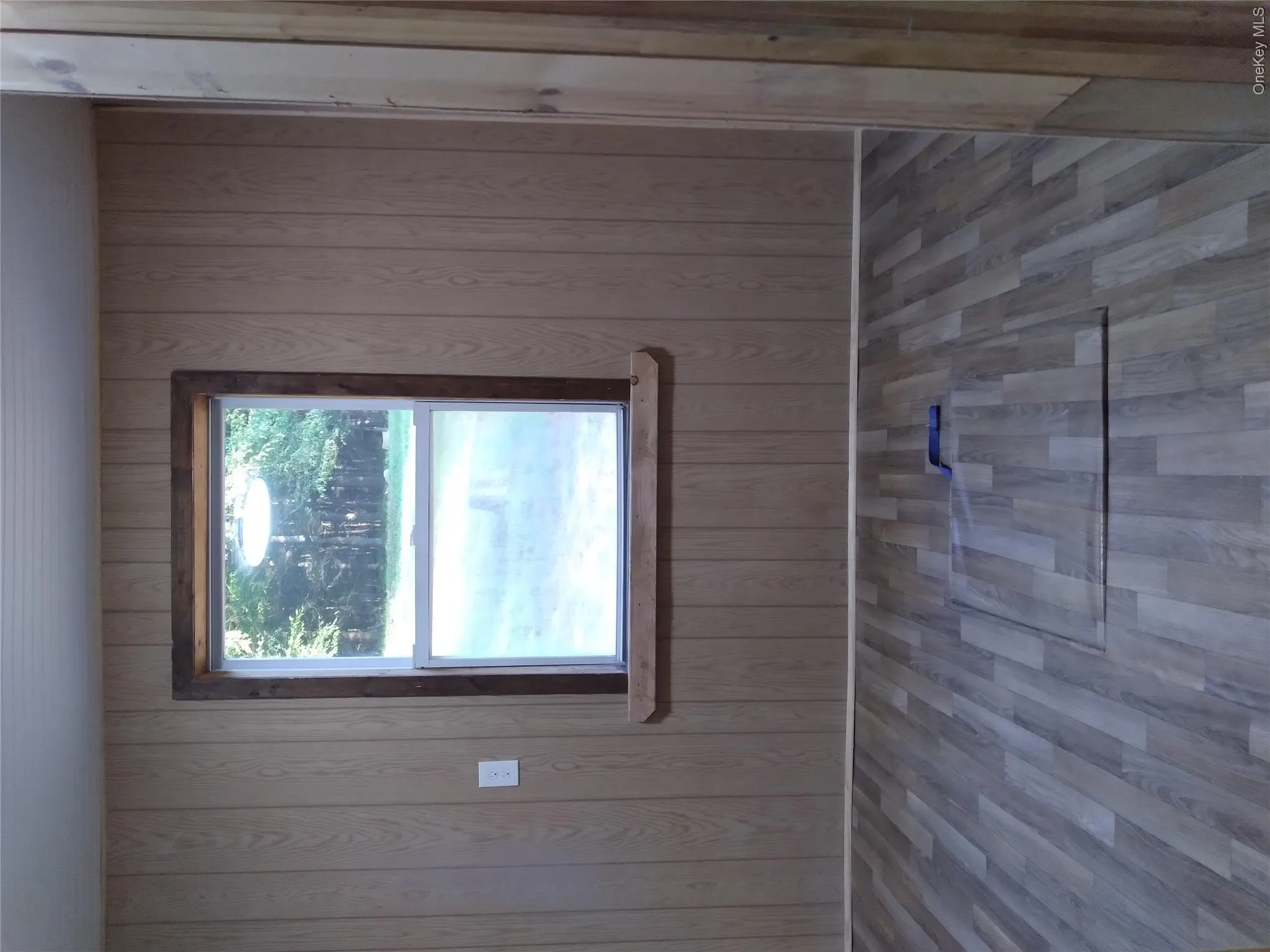 Empty room with wood finished floors and wood walls Empty room with wood finished floors and wood walls