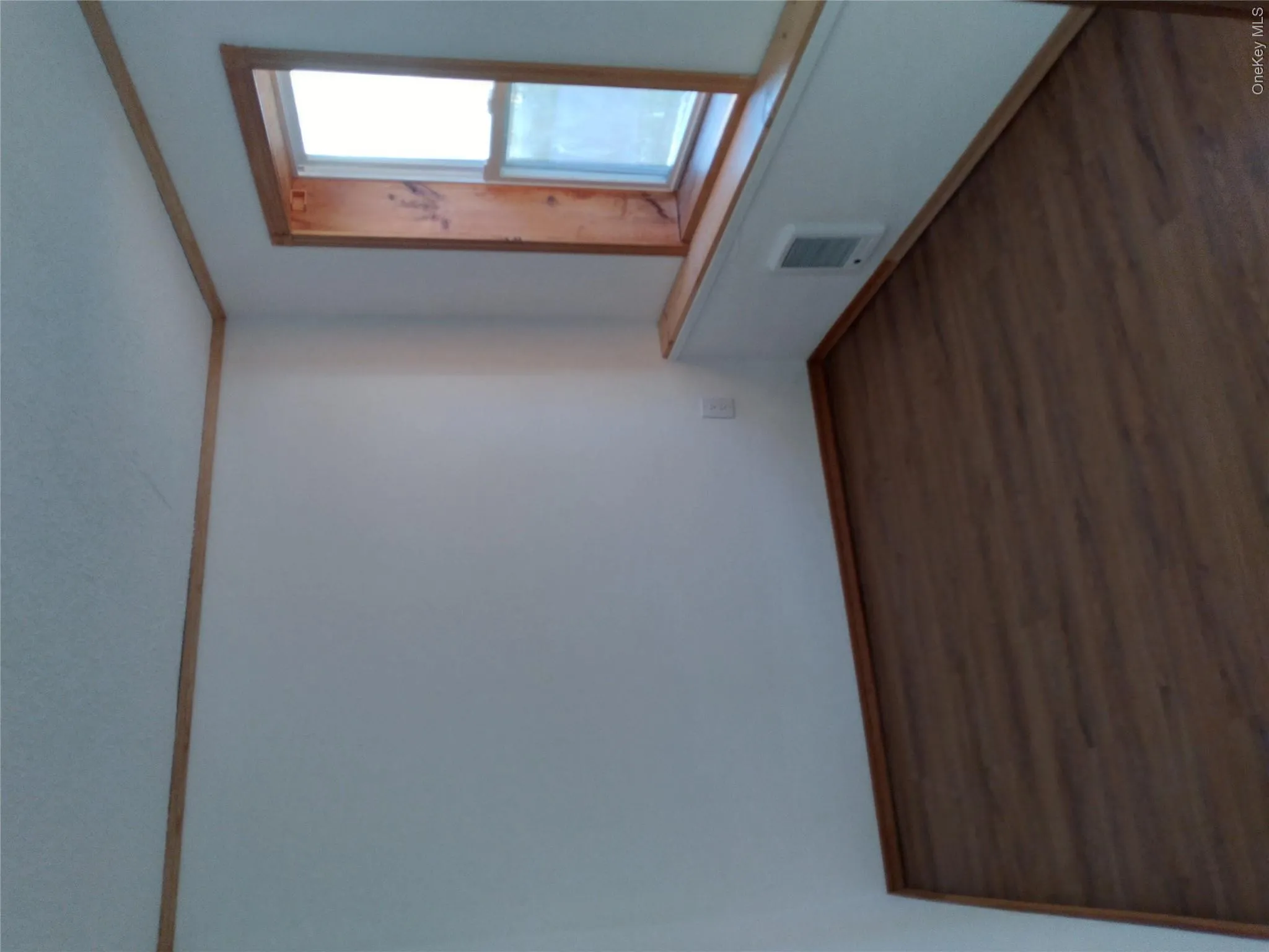 Unfurnished room with ornamental molding and dark wood-style floors Unfurnished room with ornamental molding and dark wood-style floors