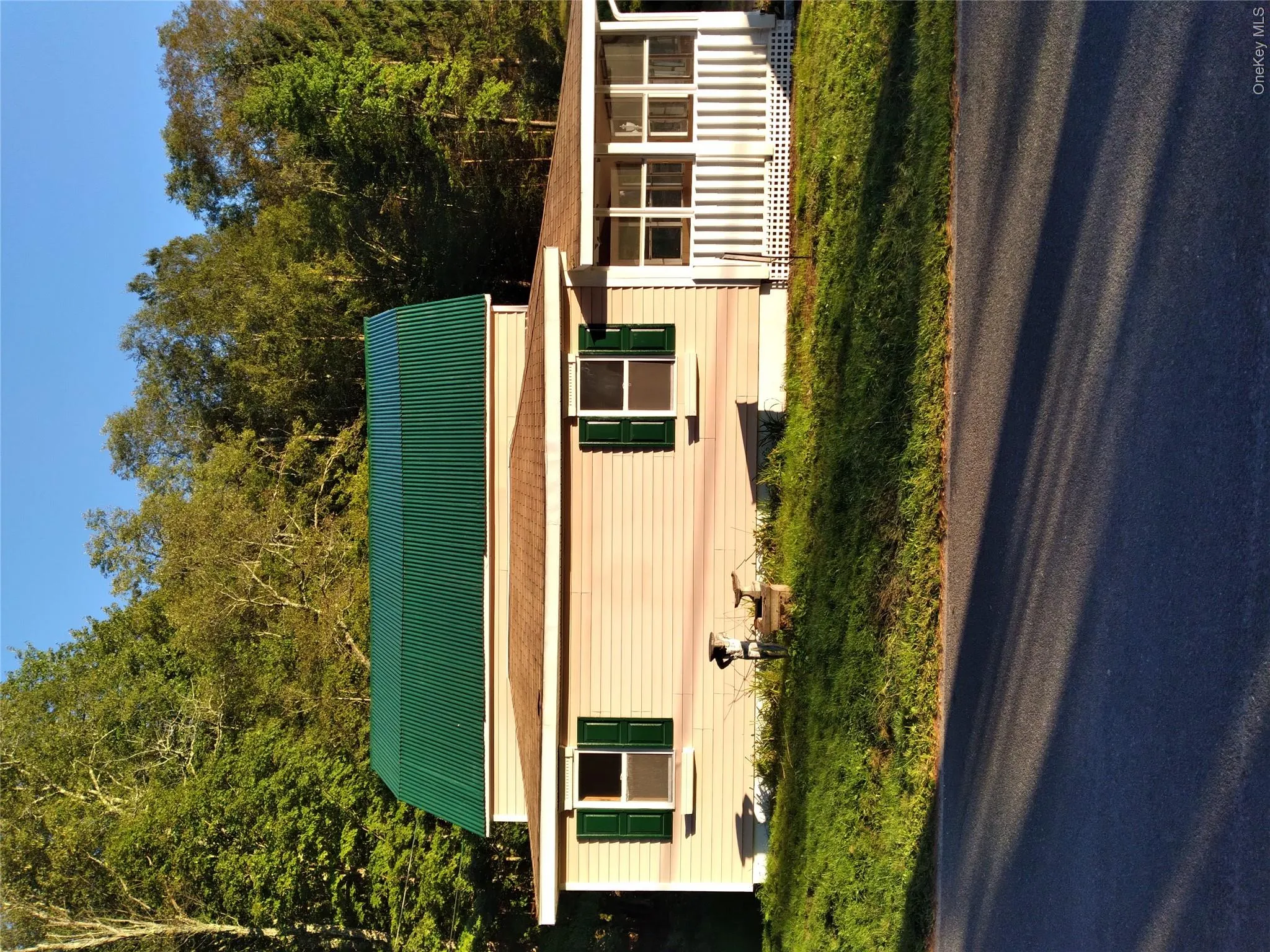 View of side of property featuring a metal roof and a yard View of side of property featuring a metal roof and a yard