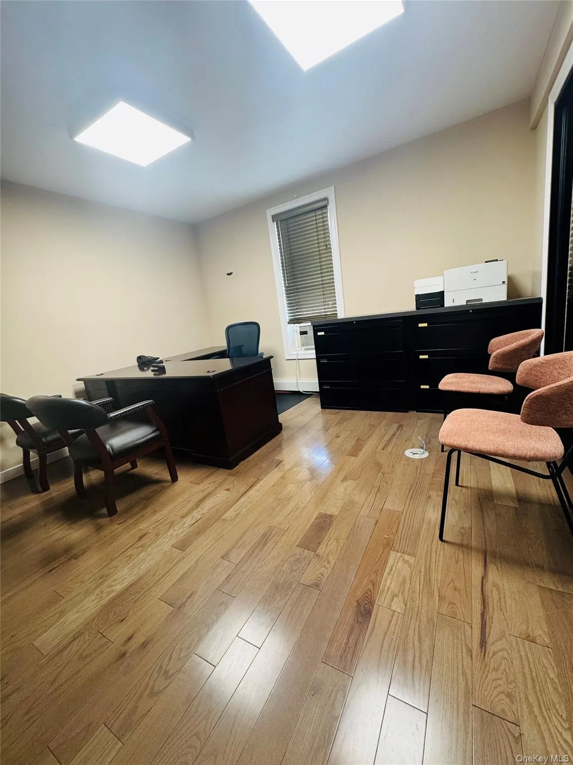 Office with light wood-style floors and baseboards Office with light wood-style floors and baseboards