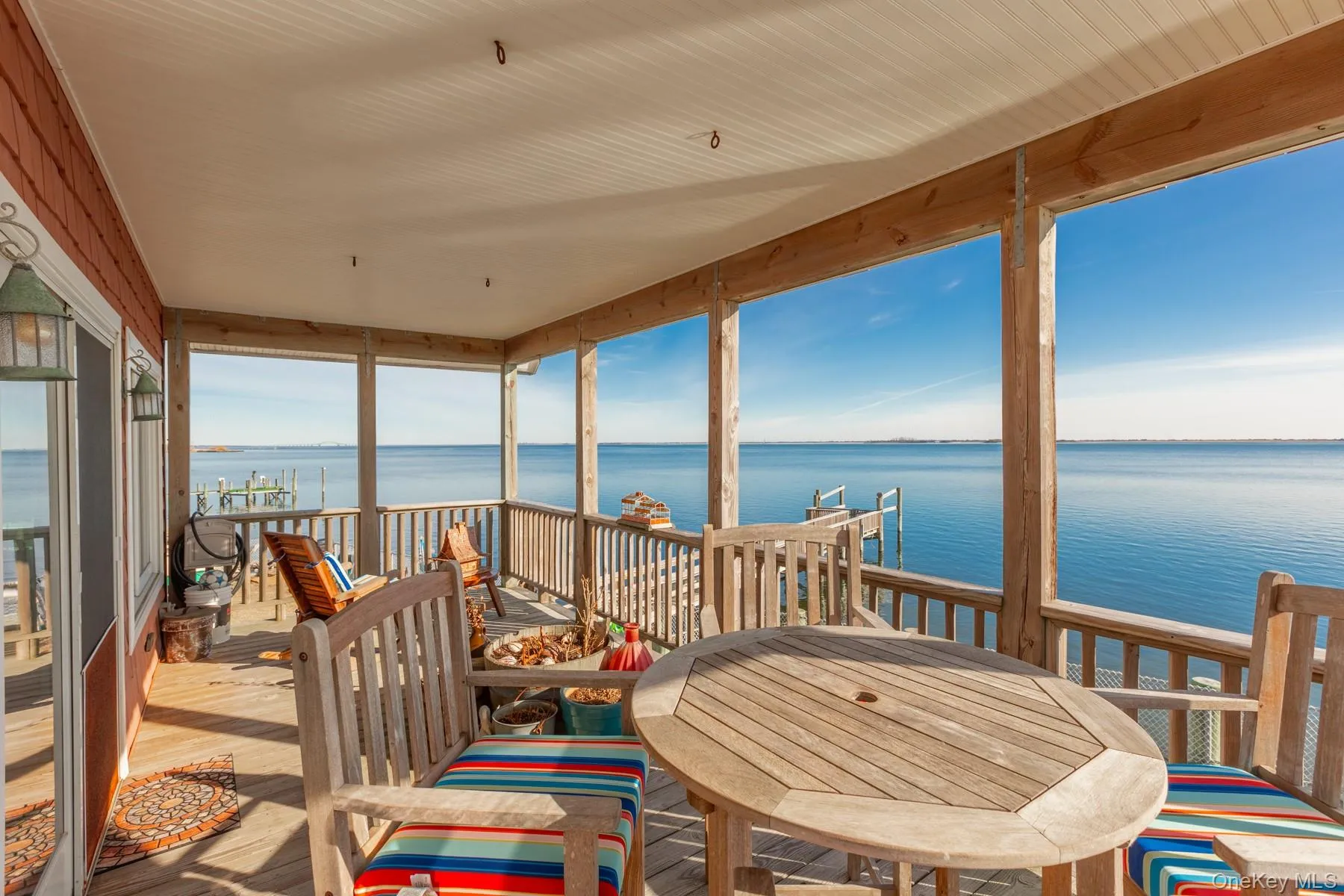 Sunroom / solarium featuring a water view Sunroom / solarium featuring a water view