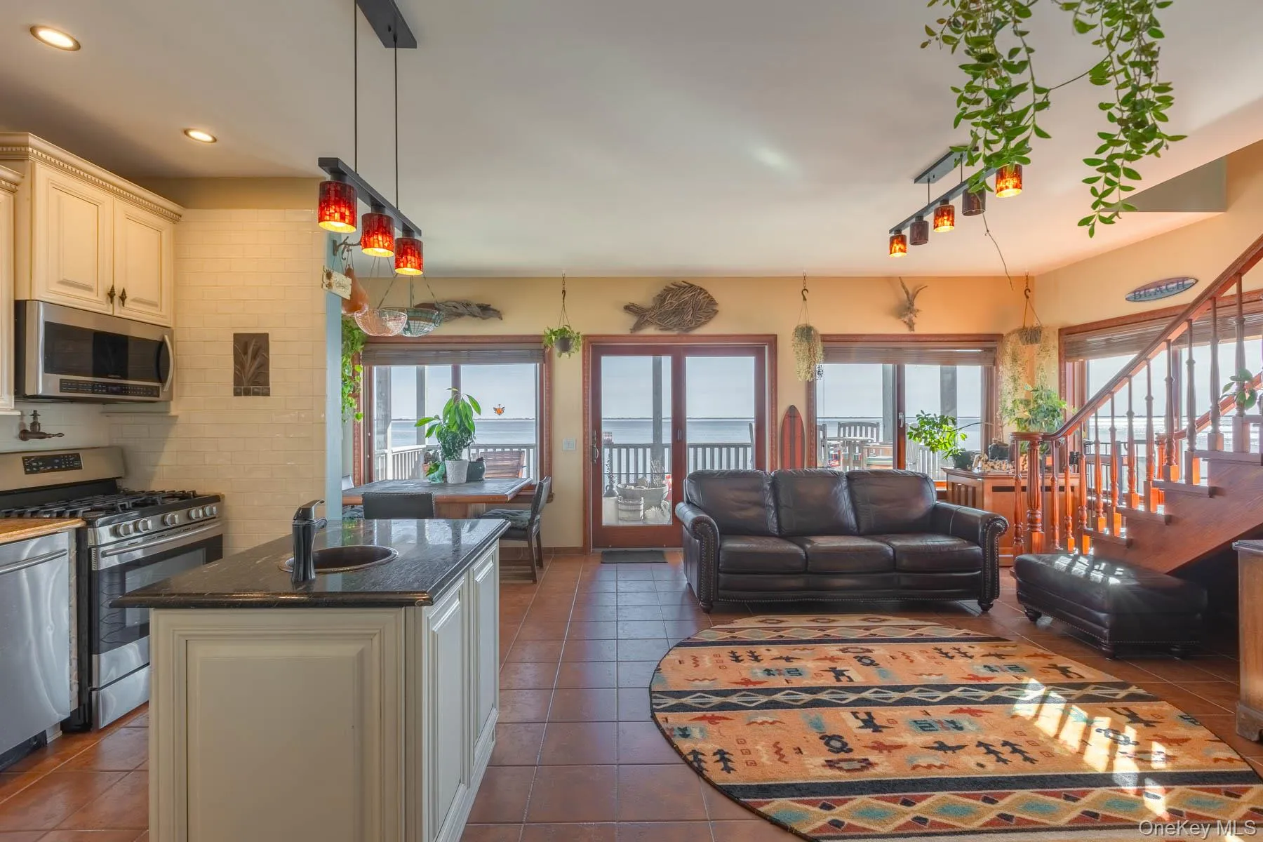 Kitchen with stainless steel appliances, open floor plan, healthy amount of natural light, hanging light fixtures, and recessed lighting Kitchen with stainless steel appliances, open floor plan, healthy amount of natural light, hanging light fixtures, and recessed lighting
