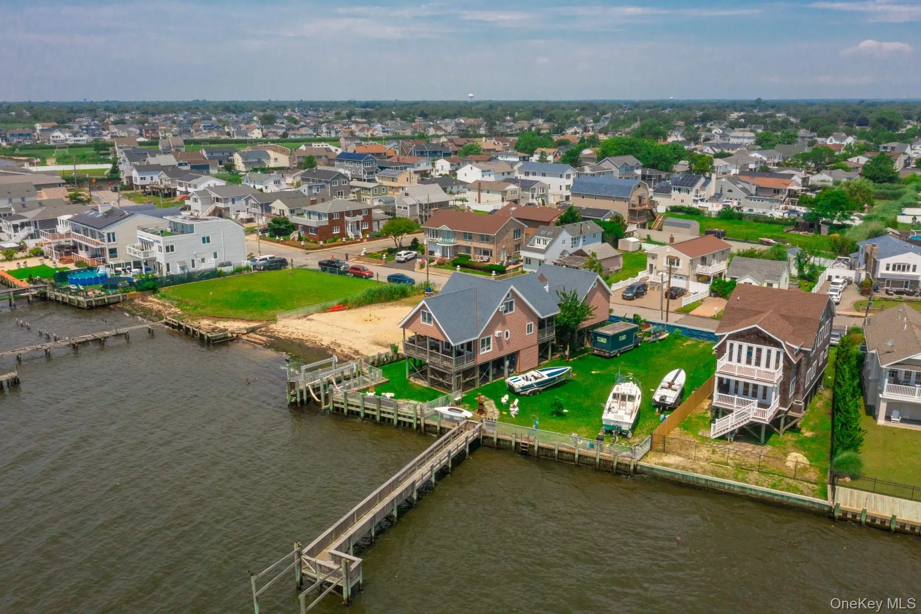 Aerial view of residential area featuring a large body of water Aerial view of residential area featuring a large body of water