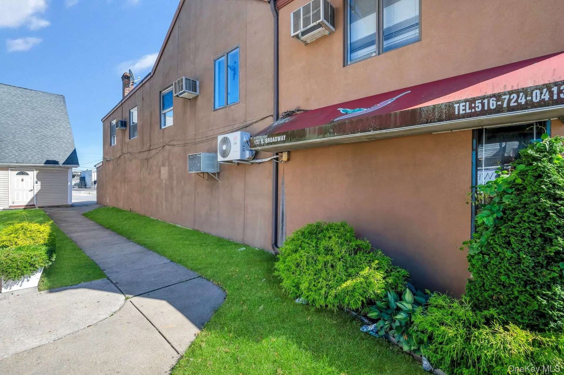 View of building exterior featuring stucco siding View of building exterior featuring stucco siding