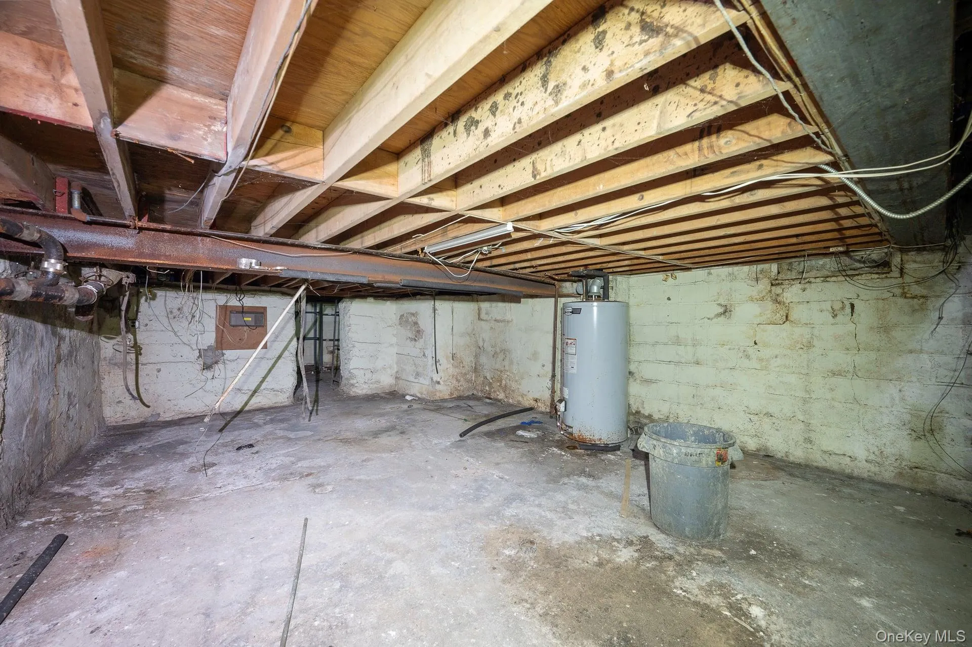 Unfinished basement with water heater Unfinished basement with water heater