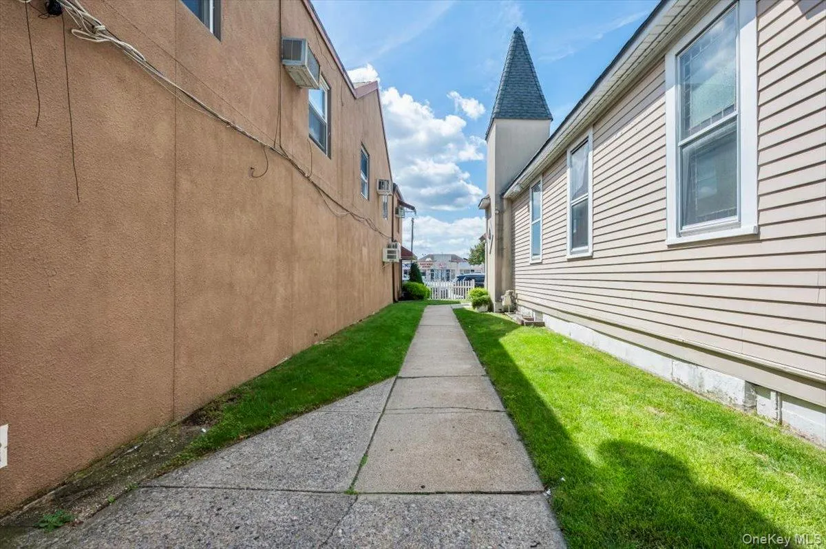 View of building exterior featuring stucco siding View of building exterior featuring stucco siding