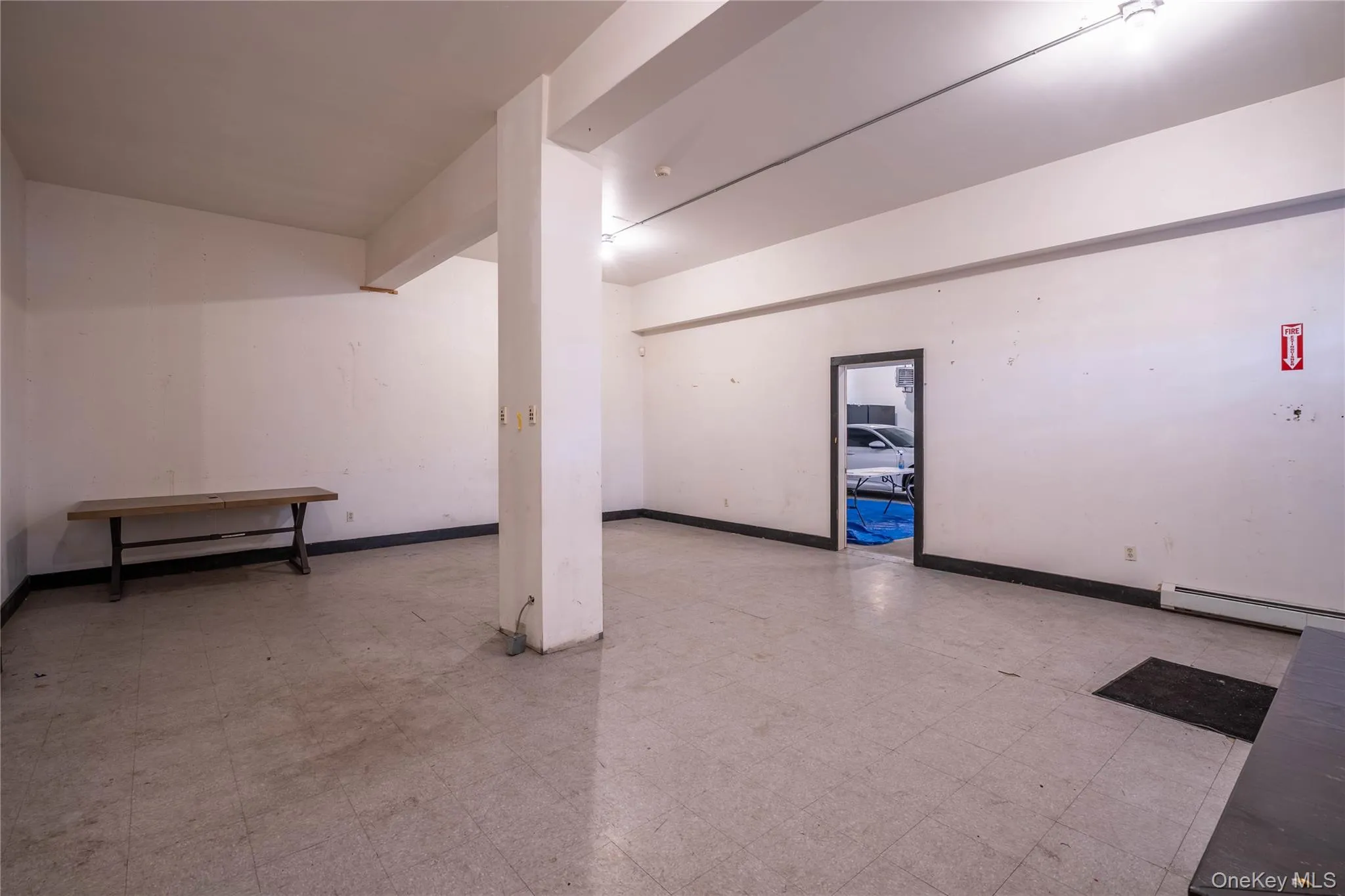 Basement with tile patterned floors and baseboard heating Basement with tile patterned floors and baseboard heating