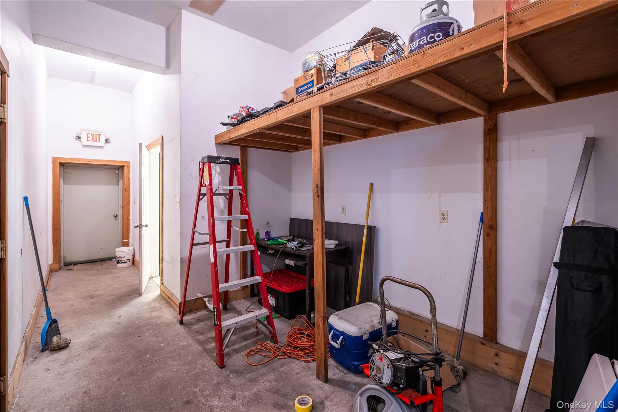Bedroom featuring unfinished concrete floors Bedroom featuring unfinished concrete floors