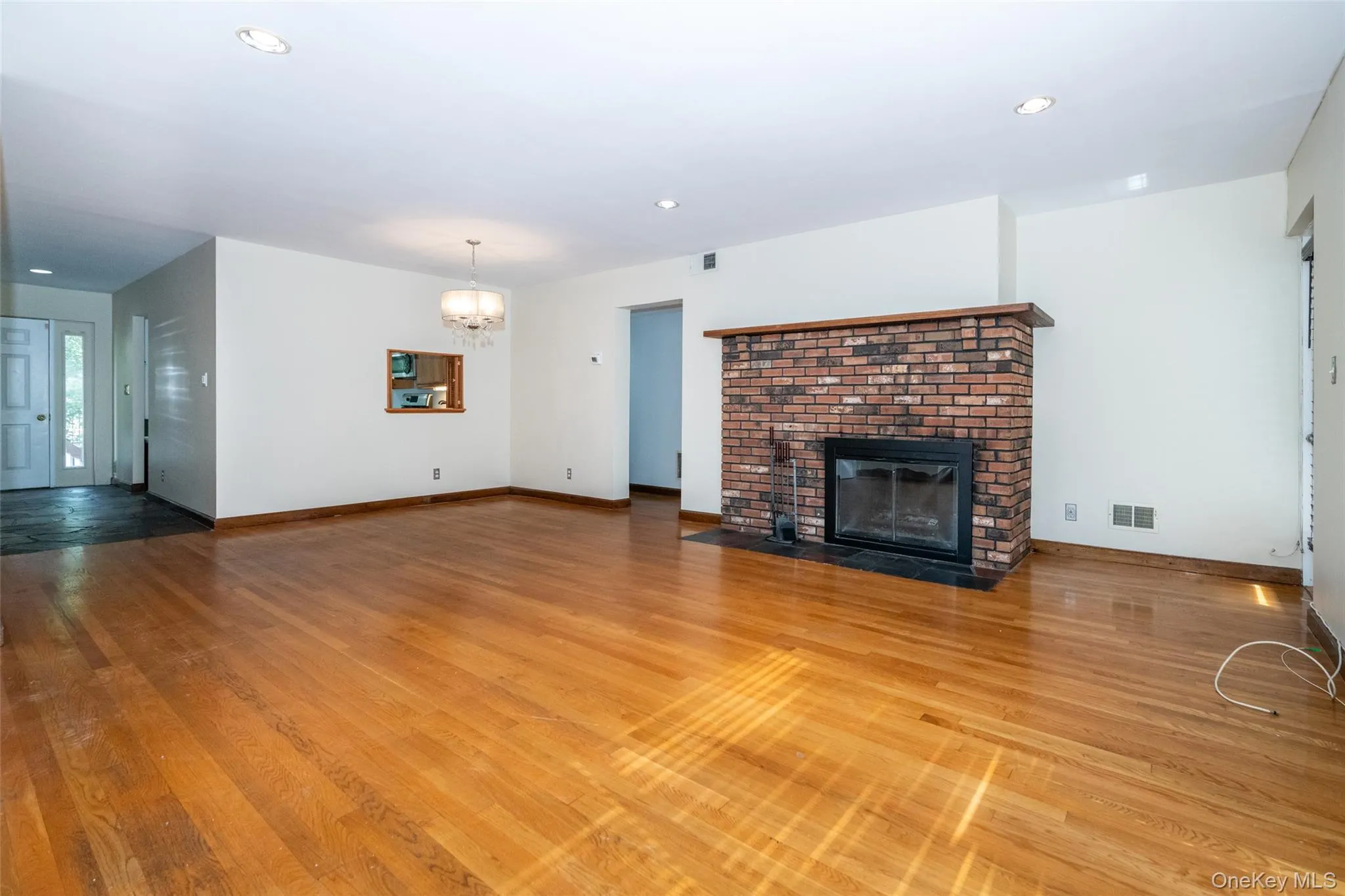 living room with recessed lighting, a fireplace, light hardwood flooring, living room with recessed lighting, a fireplace, light hardwood flooring,