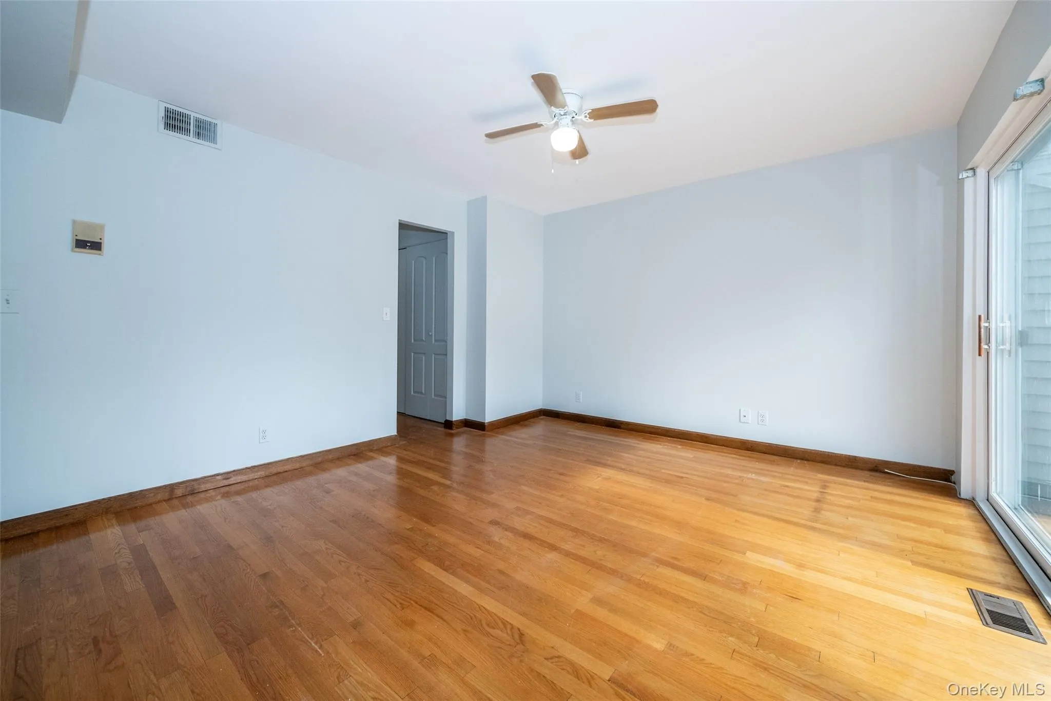 Spare room with light wood-style floors and ceiling fan Spare room with light wood-style floors and ceiling fan