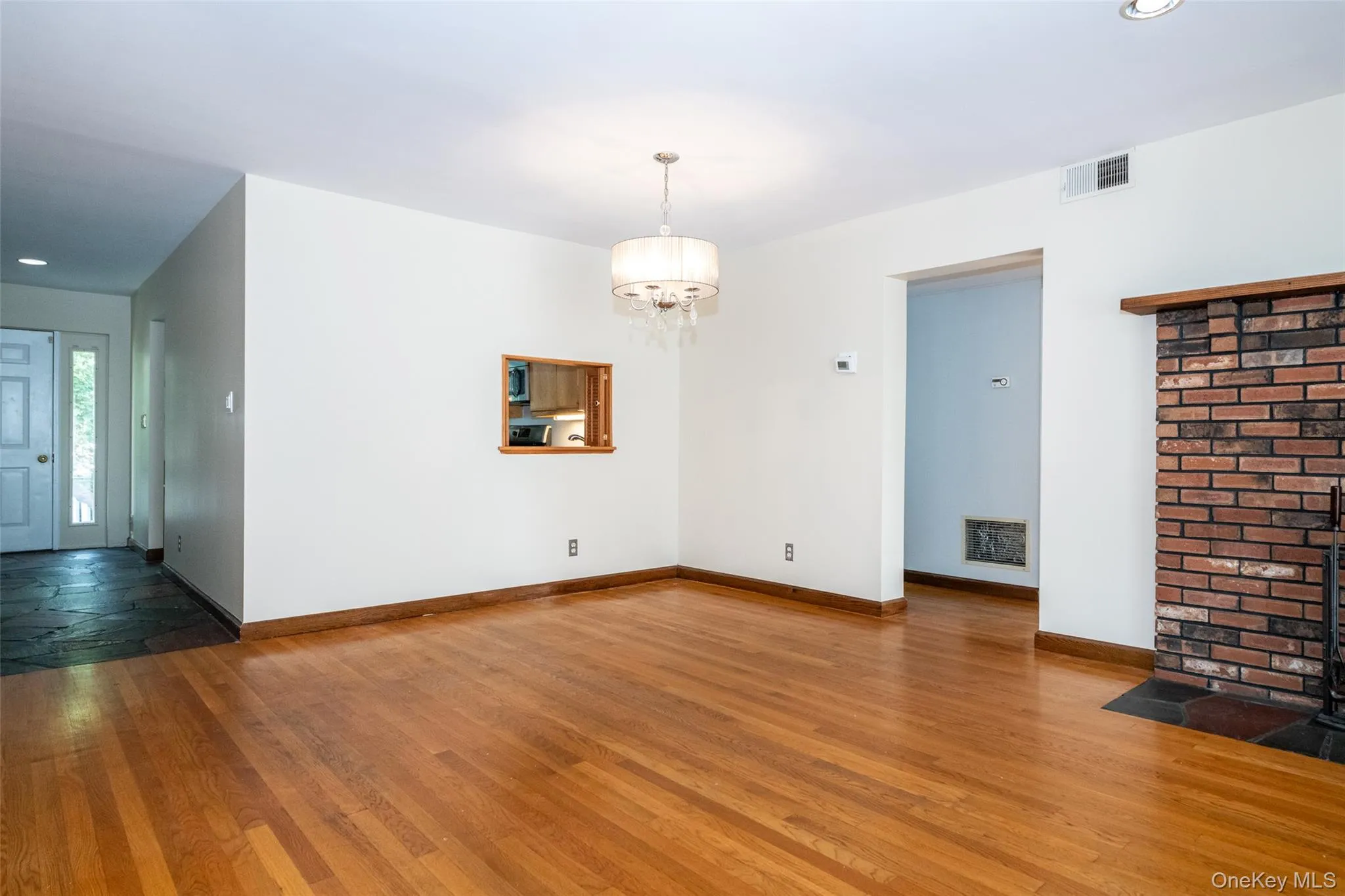 living room featuring wood finished floors, recessed lighting, and a chandelier living room featuring wood finished floors, recessed lighting, and a chandelier