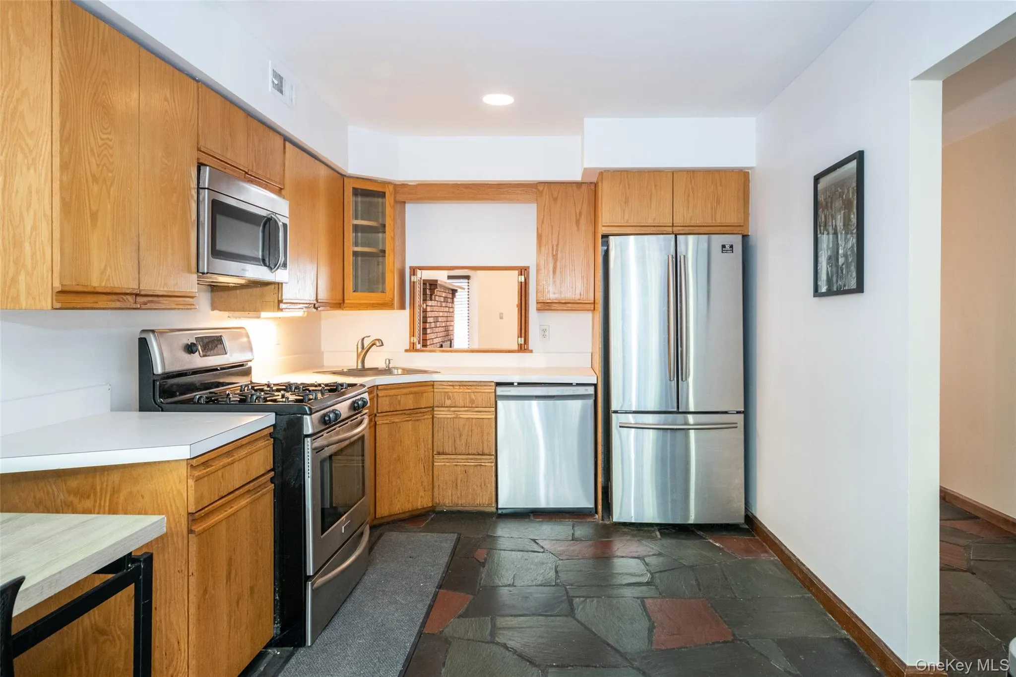 Kitchen with appliances with stainless steel finishes, stone tile floors Kitchen with appliances with stainless steel finishes, stone tile floors