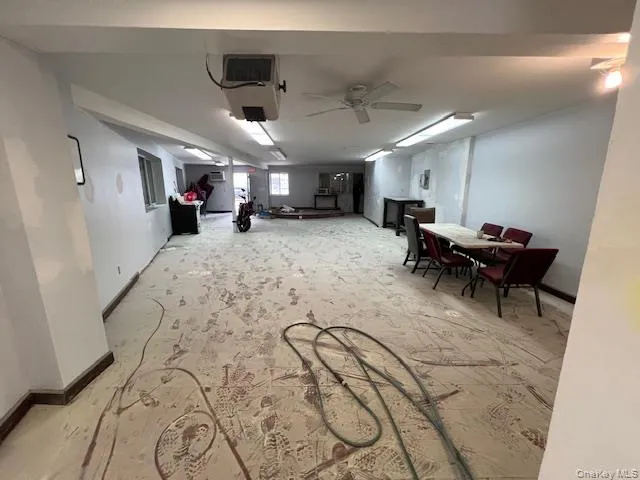 Basement featuring baseboards and ceiling fan Basement featuring baseboards and ceiling fan