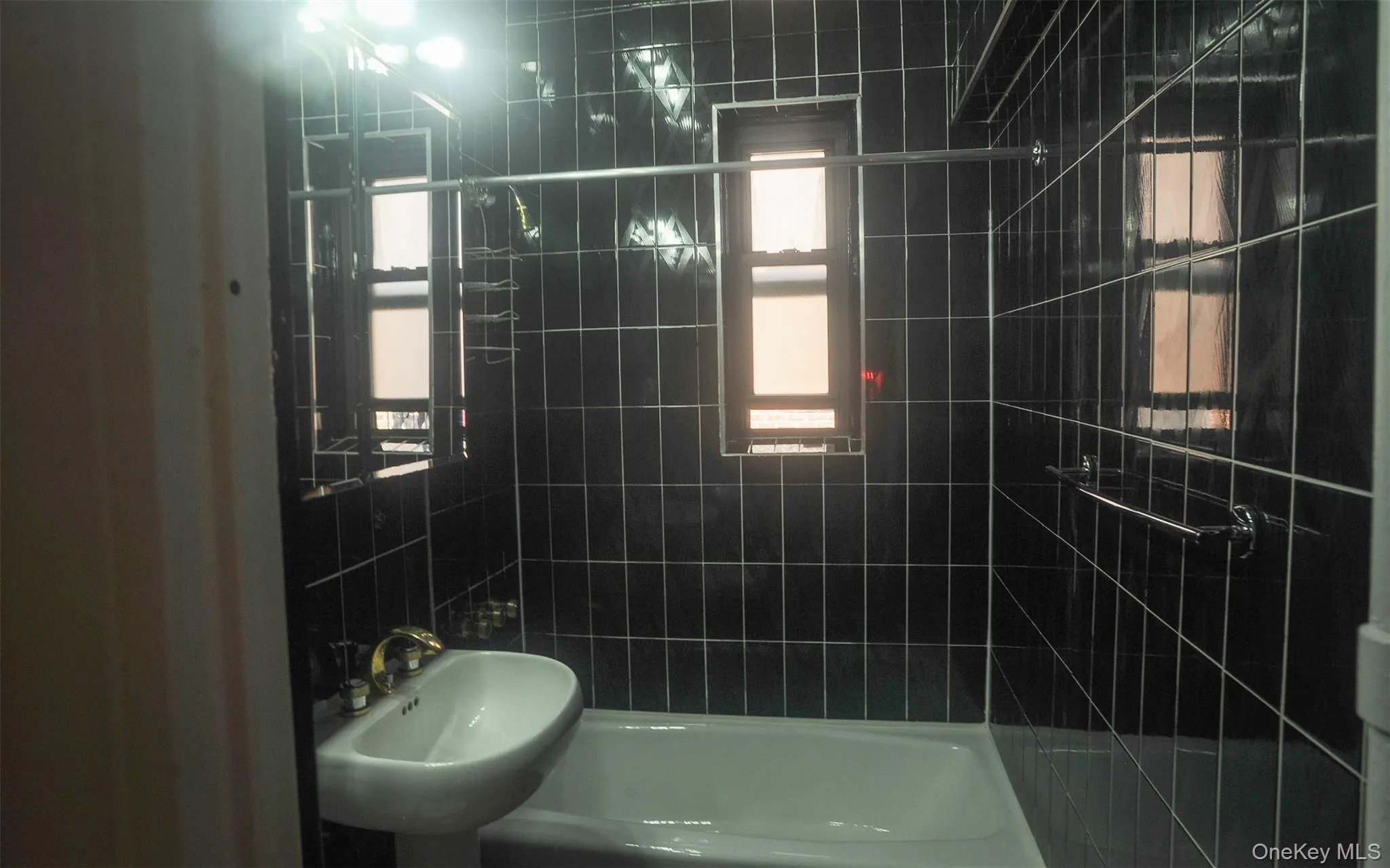 Bathroom featuring shower / bathtub combination and a sink Bathroom featuring shower / bathtub combination and a sink