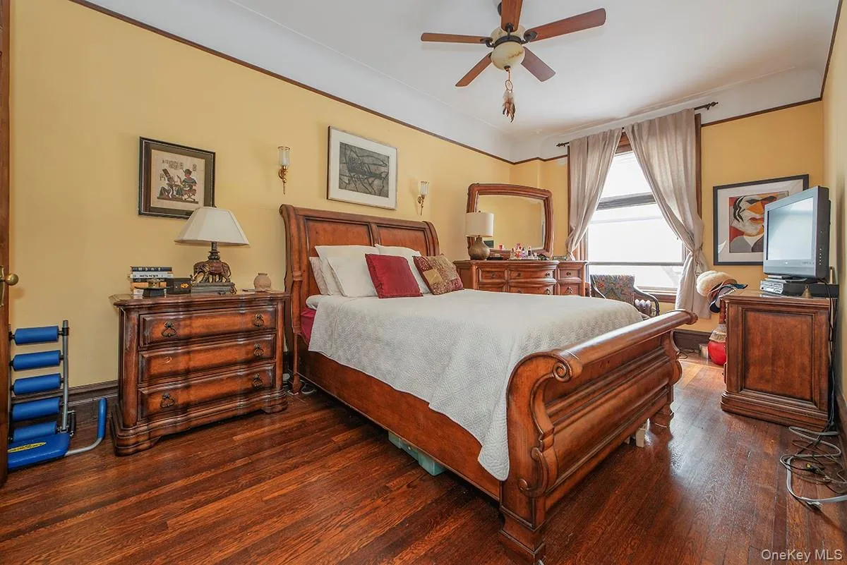 Bedroom featuring dark wood-style flooring and a ceiling fan Bedroom featuring dark wood-style flooring and a ceiling fan