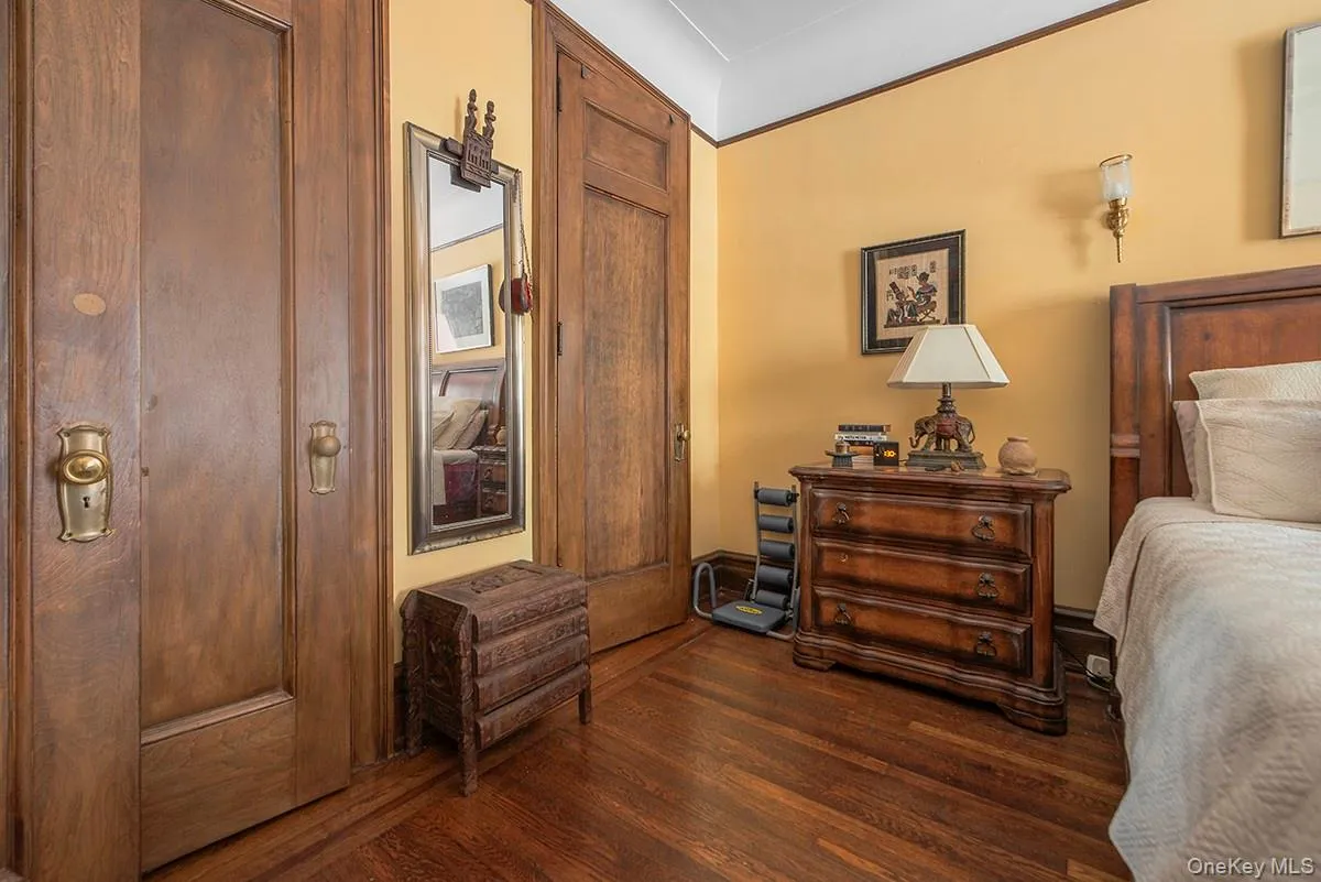 Bedroom featuring dark wood finished floors Bedroom featuring dark wood finished floors