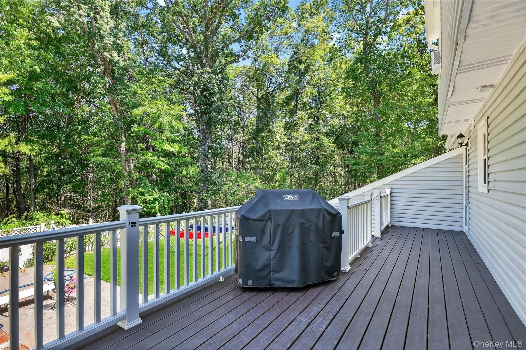 Deck with area for grilling and view of wooded area Deck with area for grilling and view of wooded area