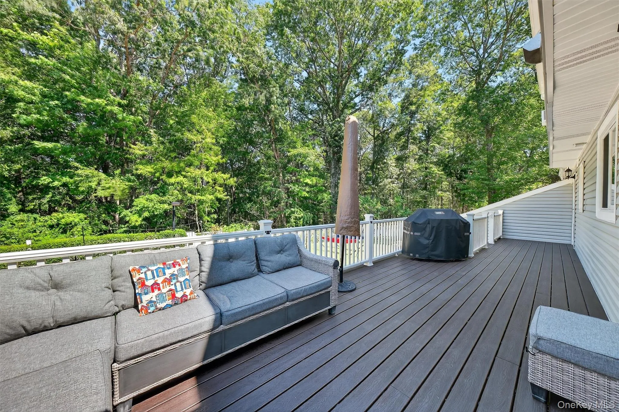 Wooden deck featuring a grill, view of scattered trees, and an outdoor living space Wooden deck featuring a grill, view of scattered trees, and an outdoor living space