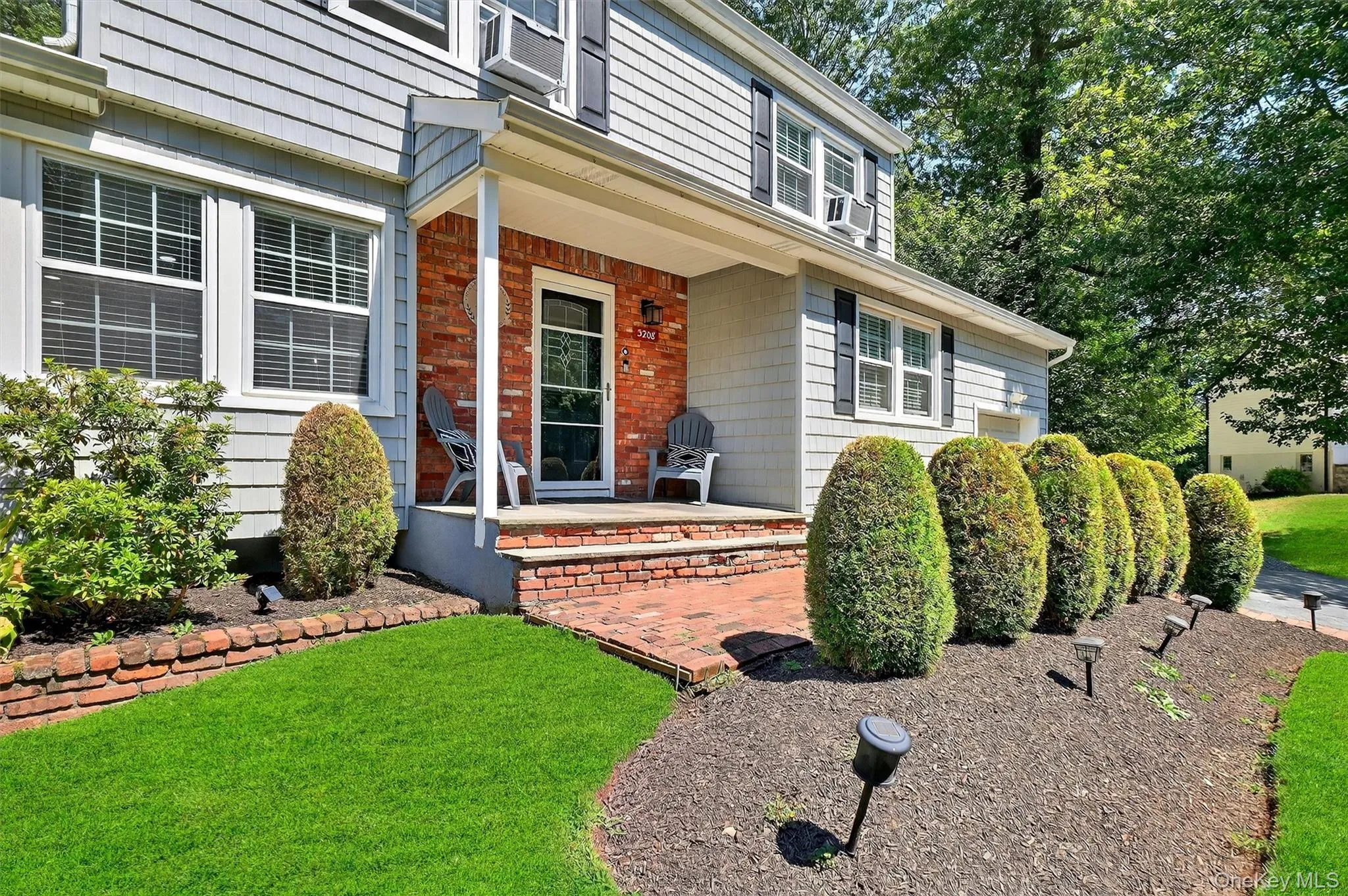 View of exterior entry with covered porch and a lawn View of exterior entry with covered porch and a lawn